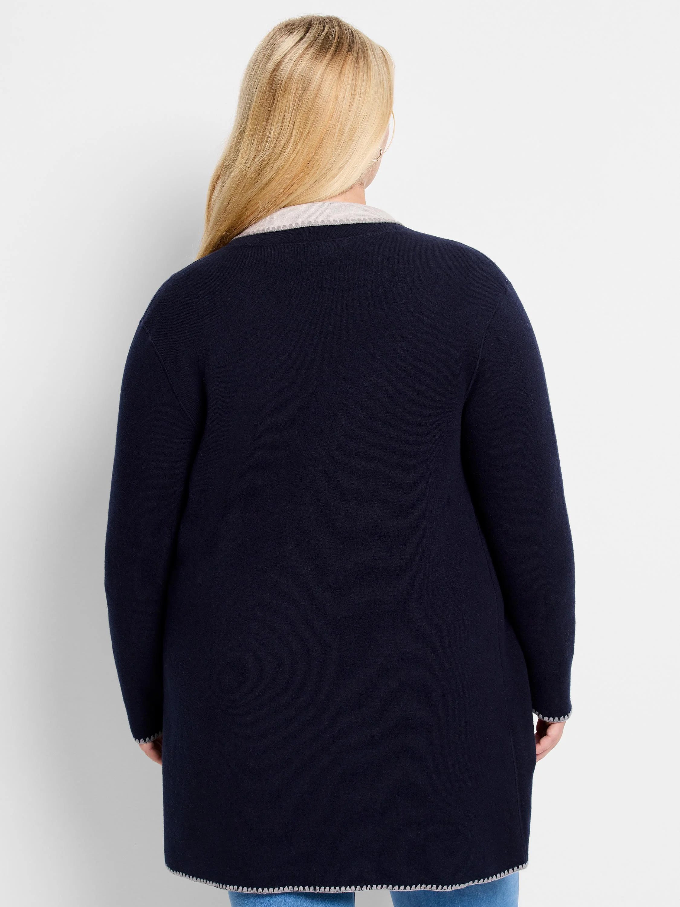 Dark blue long knit jacket with light grey scalloped trim on collar, cuffs, and hem.