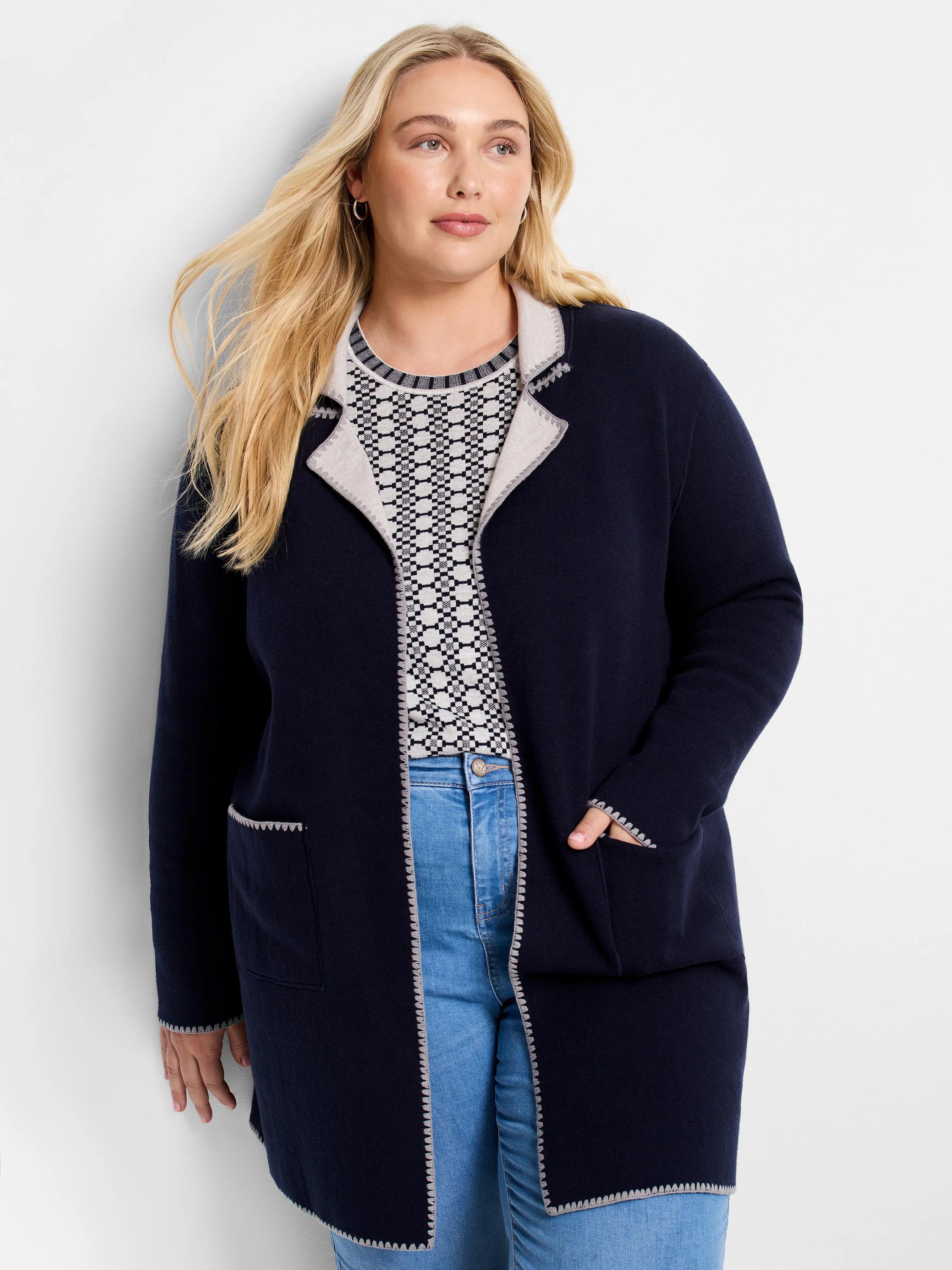 Navy knit jacket with light grey scalloped trim on lapels, front, pockets, cuffs, and hem.