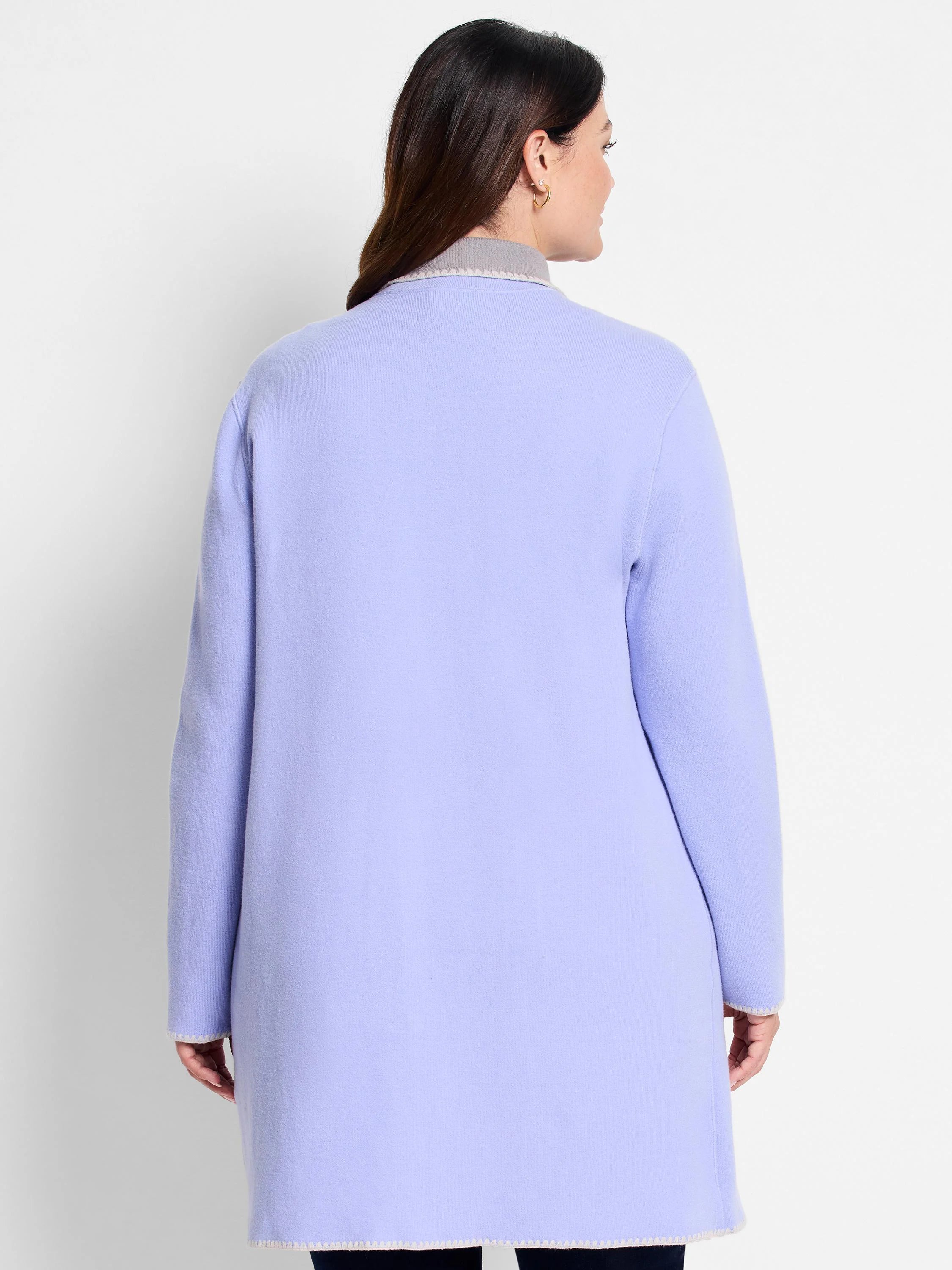 Light purple knit jacket with long sleeves, grey collar, and cream zig-zag trim on edges.