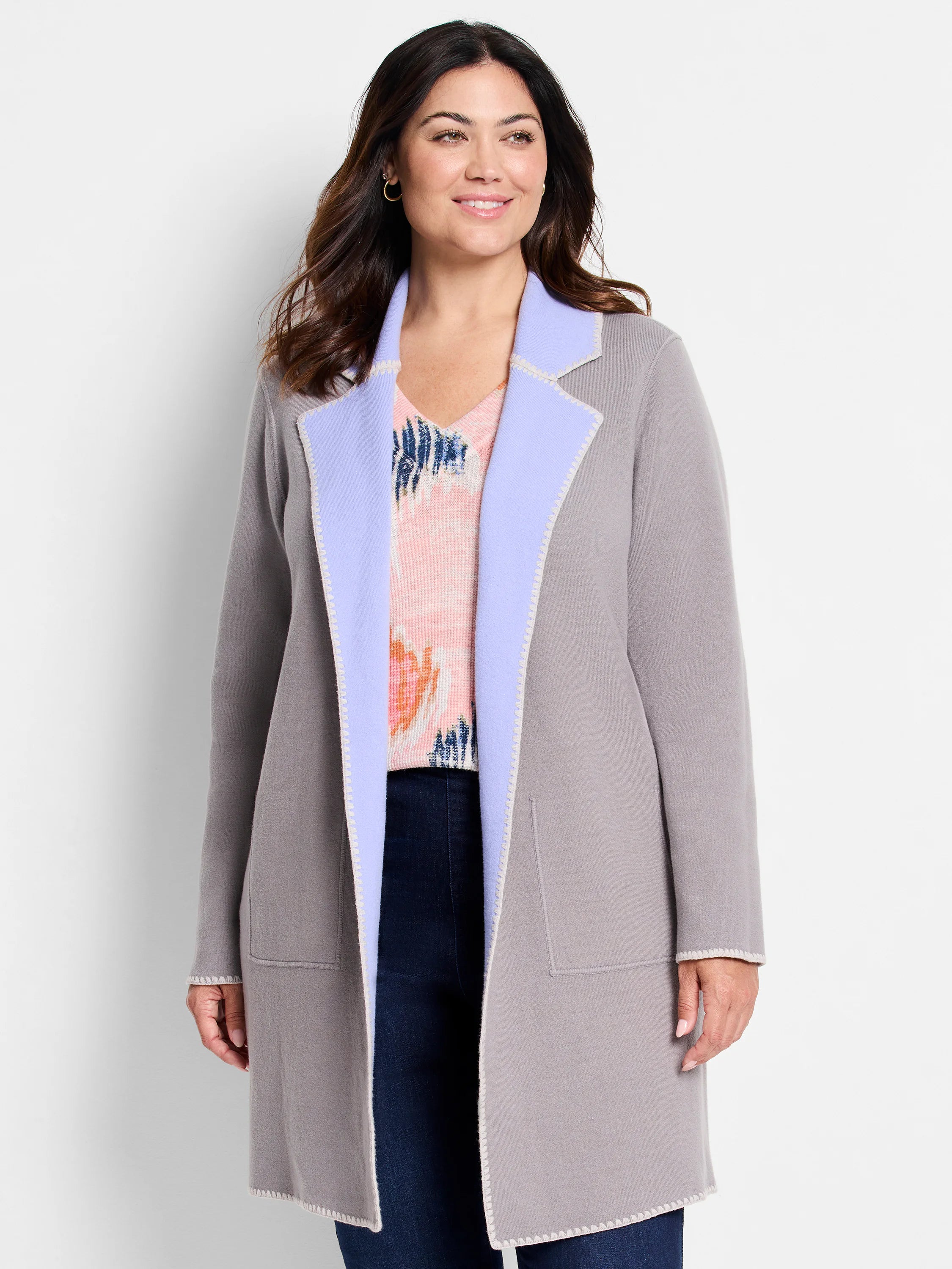 Light grey knit jacket with lavender reversible lapels, distinct white edge stitching, and open front.