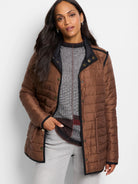 Brown quilted puffer jacket with black trim and bronze snap buttons.