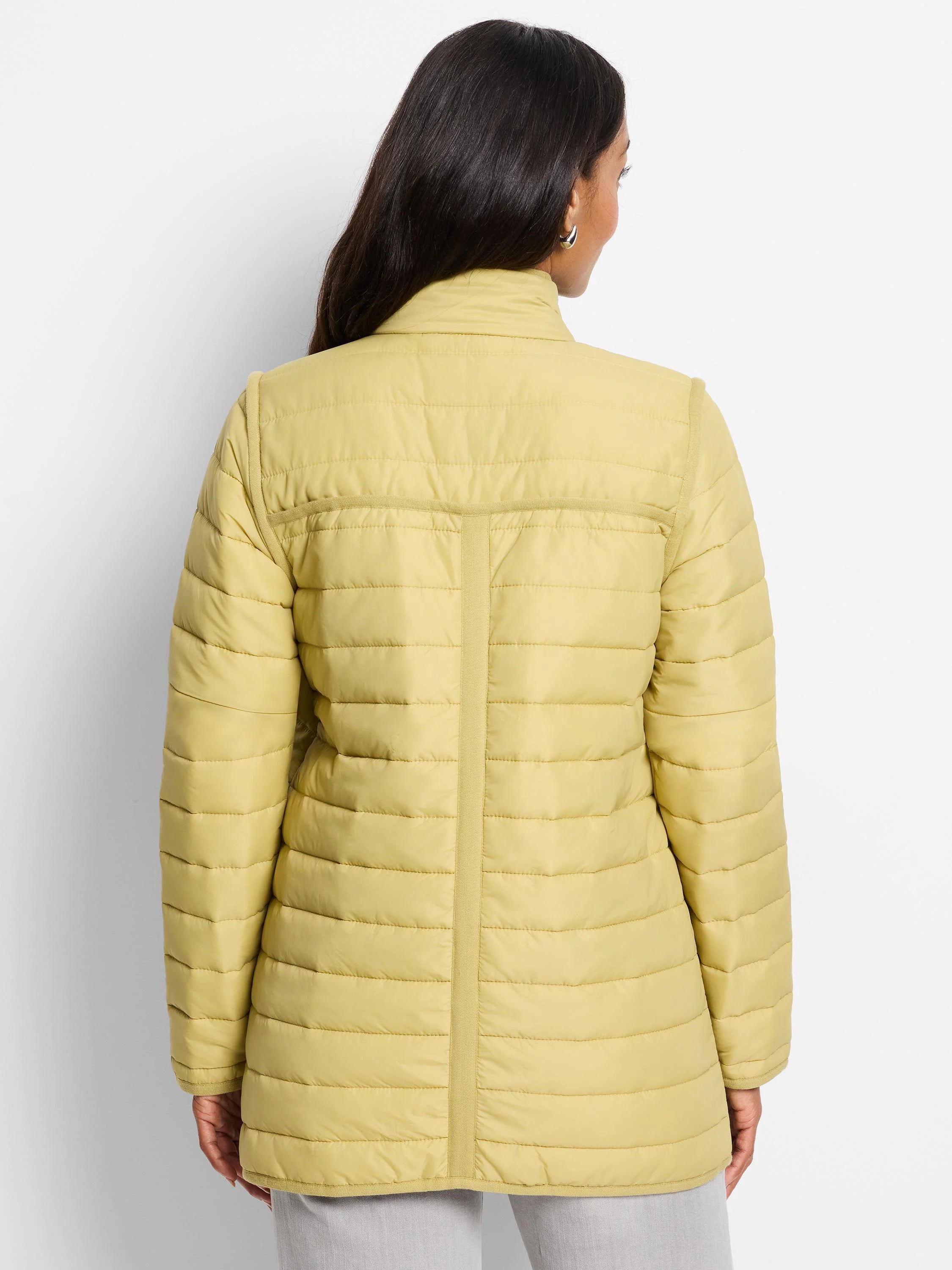 Light yellow puffer jacket with horizontal quilting, stand-up collar, and ribbed trim.