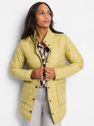 Light yellow reversible puffer jacket with a stand collar, snap buttons, and front pockets. Patterned lining.