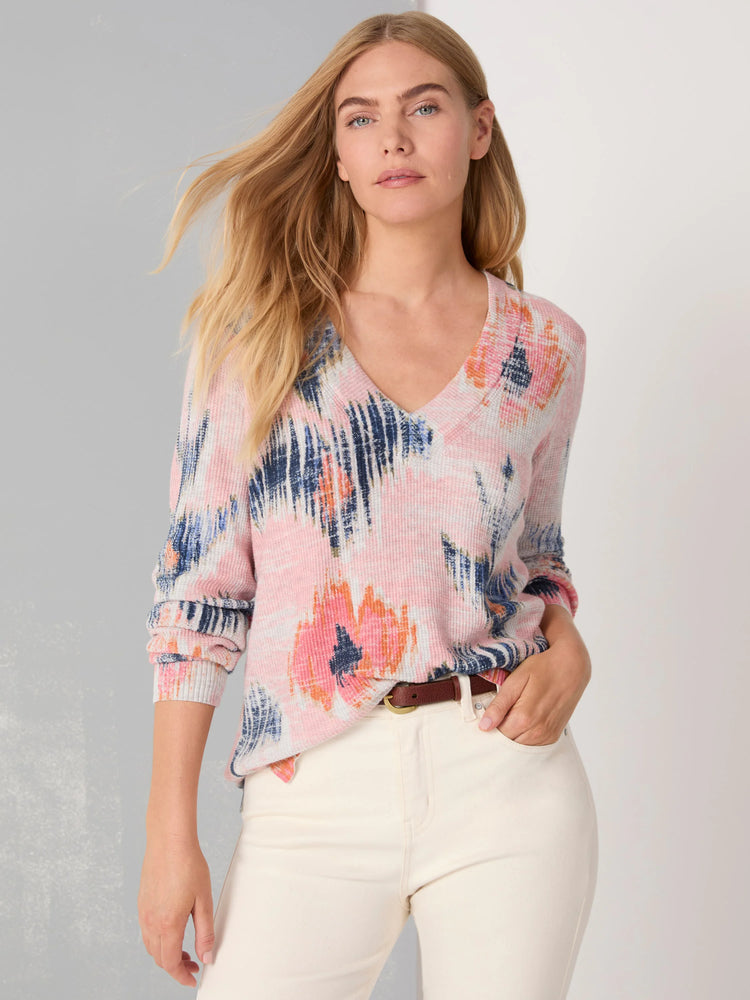 V-neck waffle knit sweater in pink, white, blue & coral abstract pattern. Ribbed texture, long sleeves.