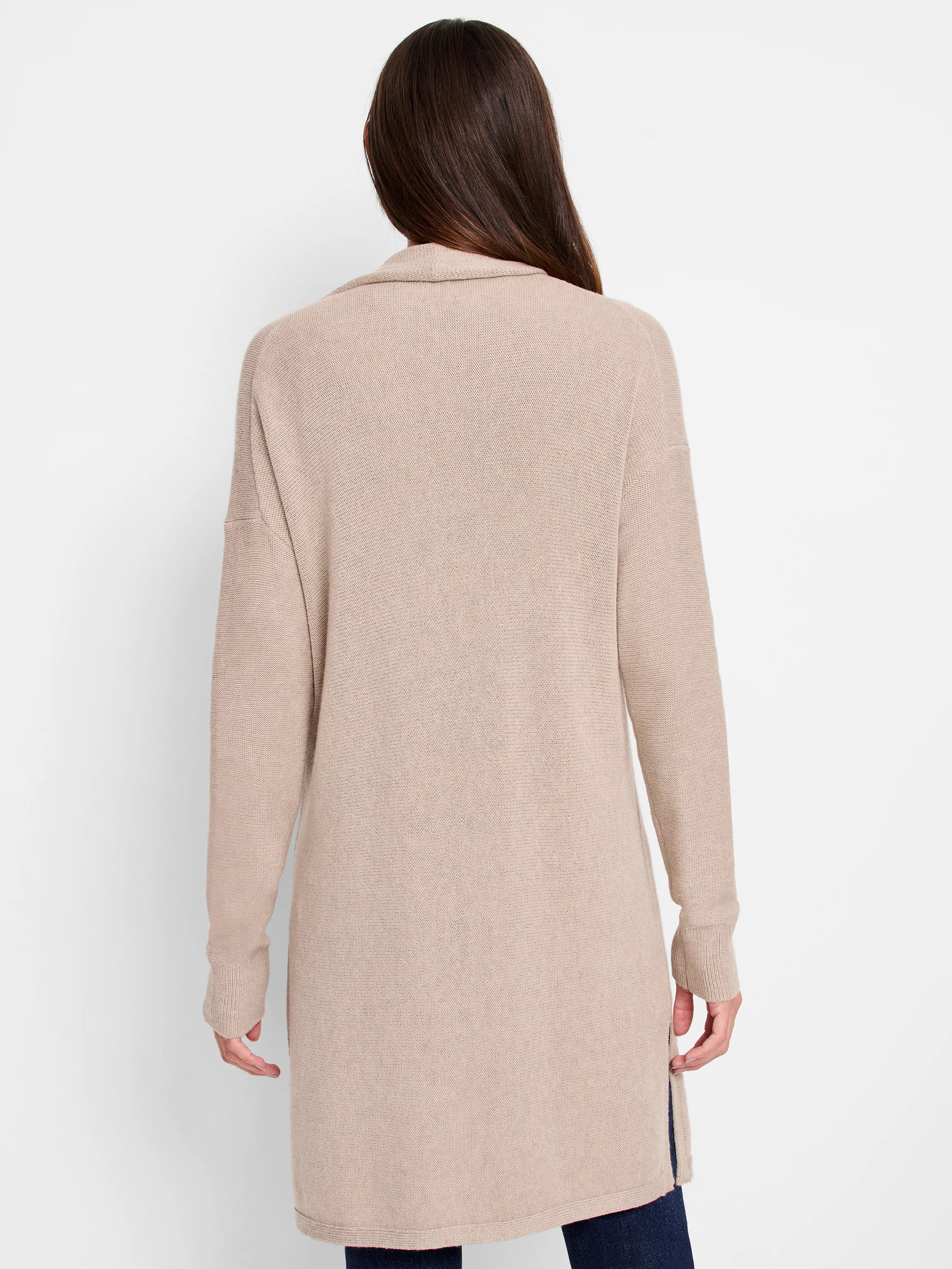 Long beige knit cardigan, back view on a model. Features long sleeves and side slits.