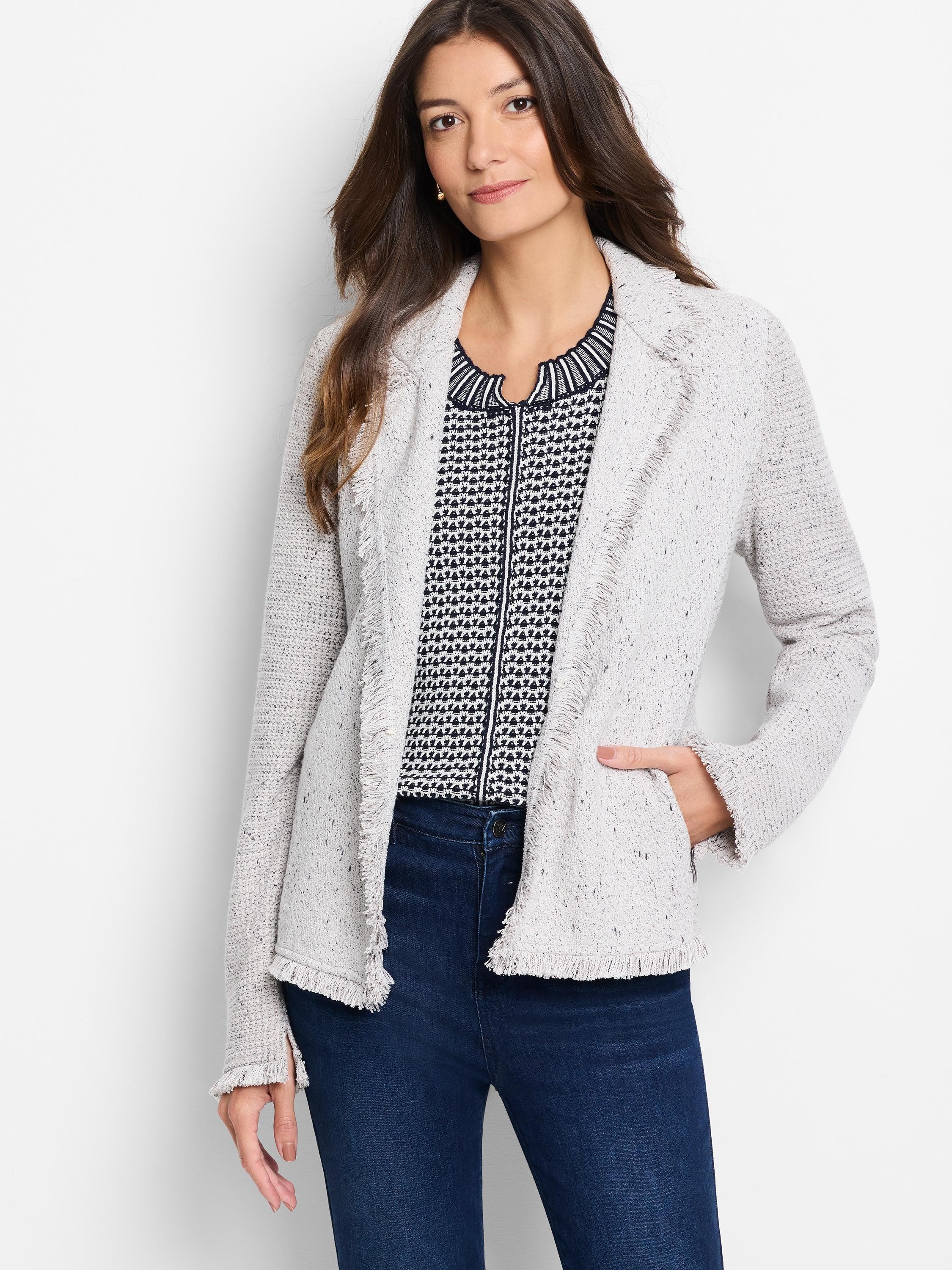 Light grey mixed knit open-front jacket with fringe trim along the collar, front opening, and cuffs.