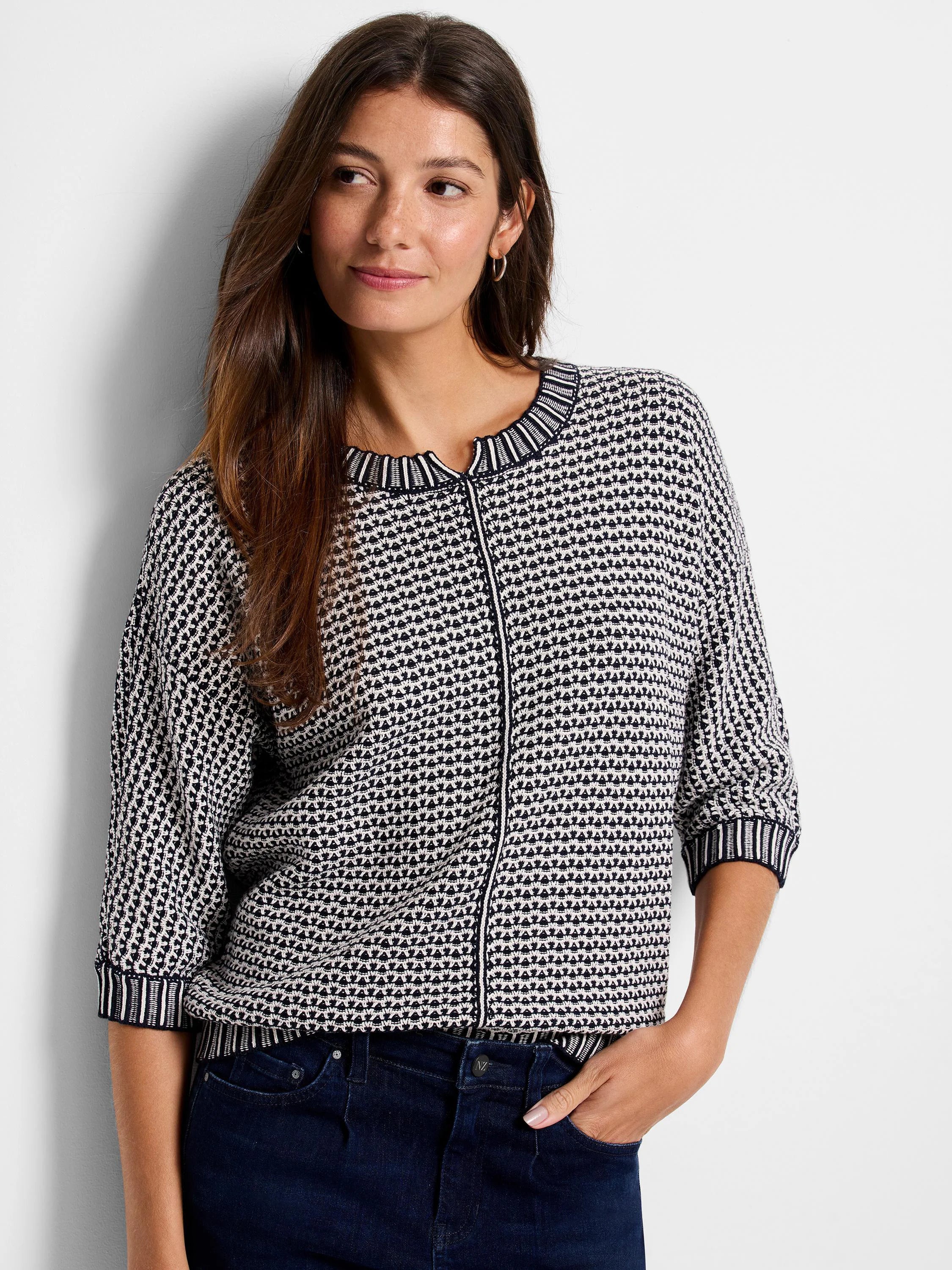 Navy and cream tuck stitch sweater with textured pattern, round neck, 3/4 sleeves, and striped ribbed trim.