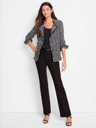 Black and white chevron knit jacket with fringe on collar, open front, cuffs, and hem.
