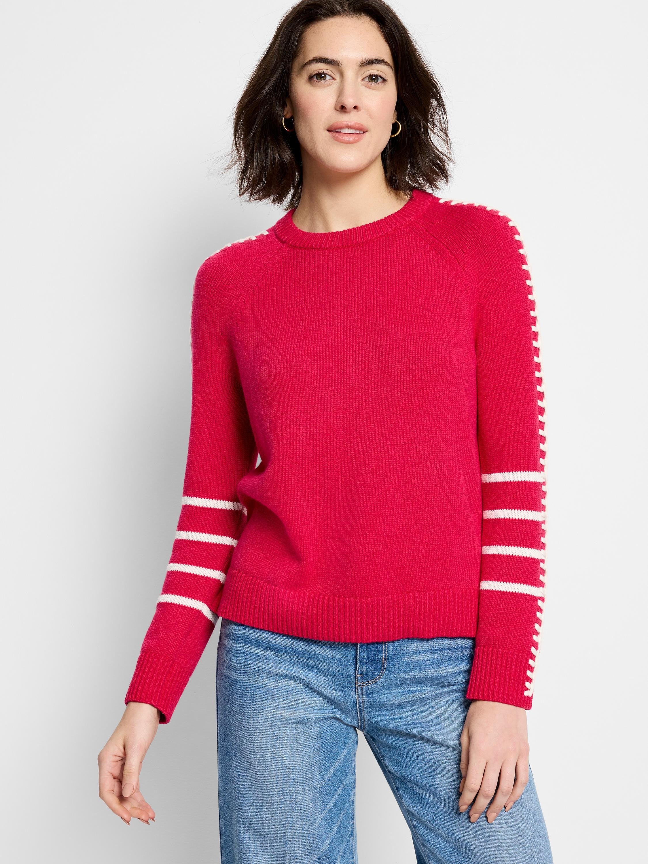 Red crewneck sweater with white dashed stitching on shoulders and white horizontal stripes on sleeves.
