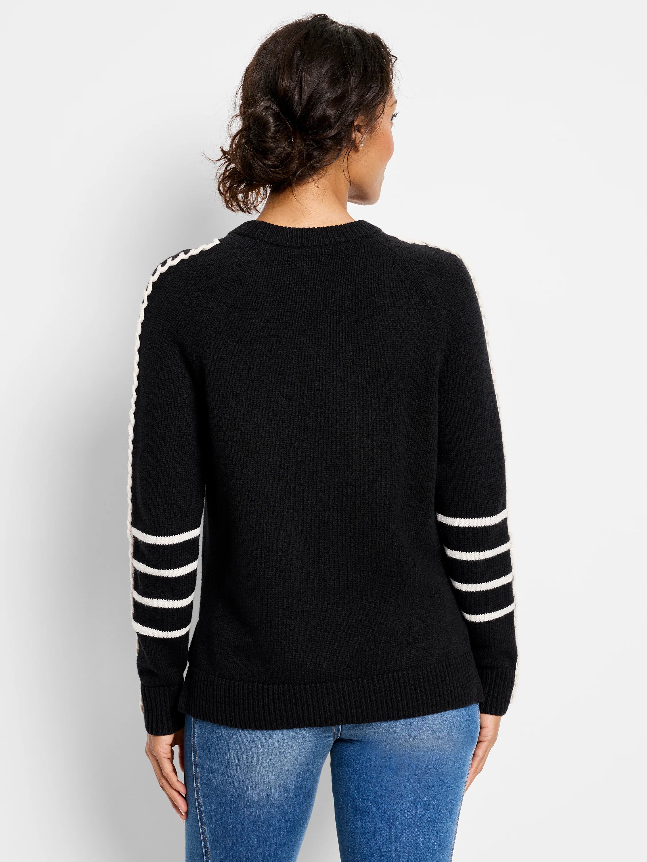Black sweater with a white dashed stripe down each outer sleeve and three white stripes on each forearm.