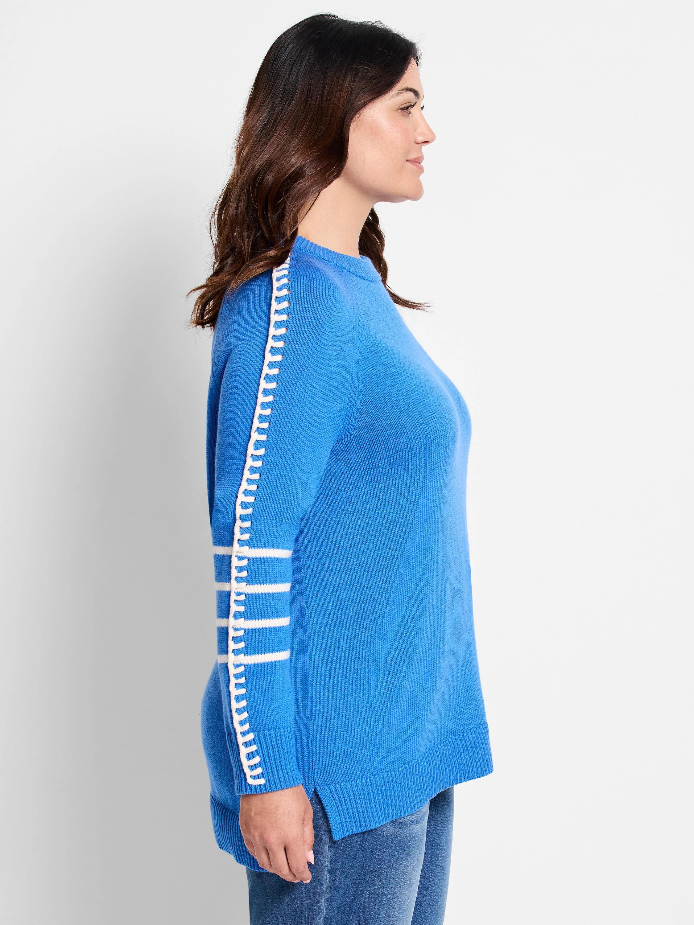 Cobalt blue knit sweater with white loop trim down shoulder seam and three white sleeve stripes.