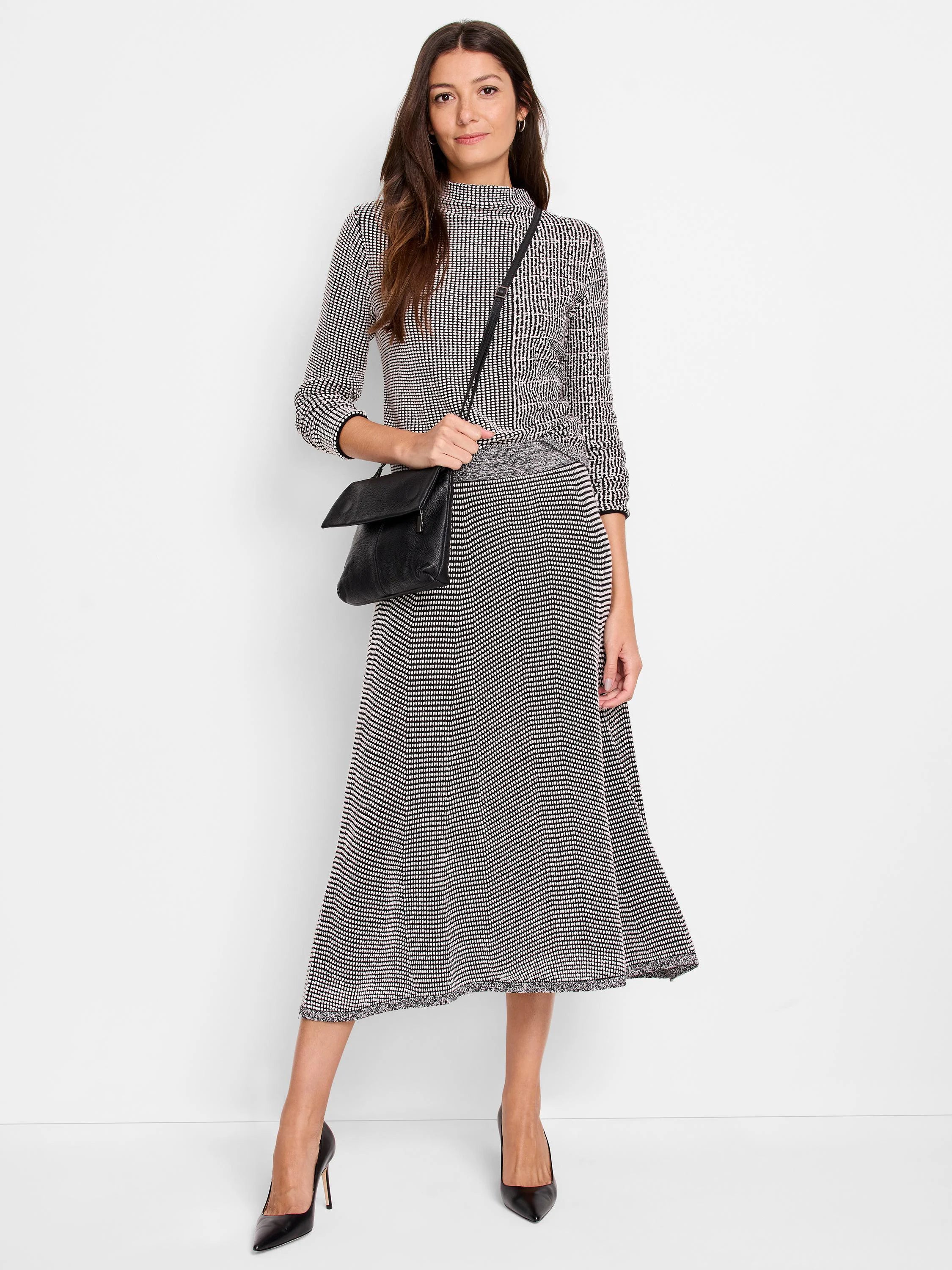Black and white patterned knit midi skirt. A-line shape with a textured knit.