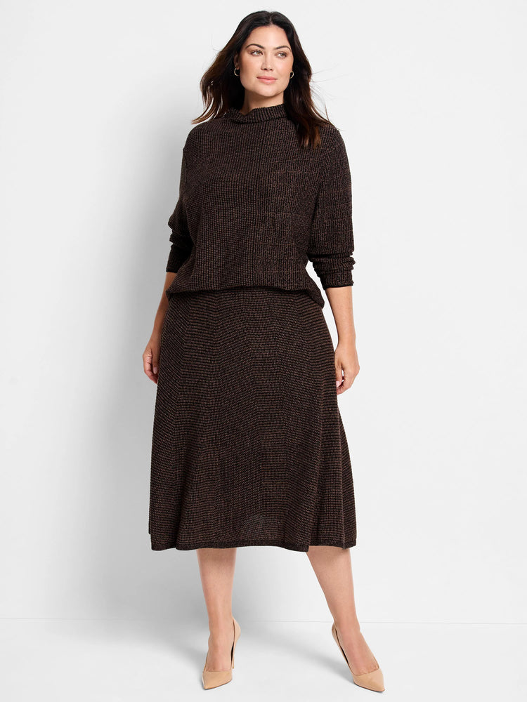 Dark brown pixel knit sweater with bronze flecks, high neck, and long sleeves. Worn by a model with a matching skirt.