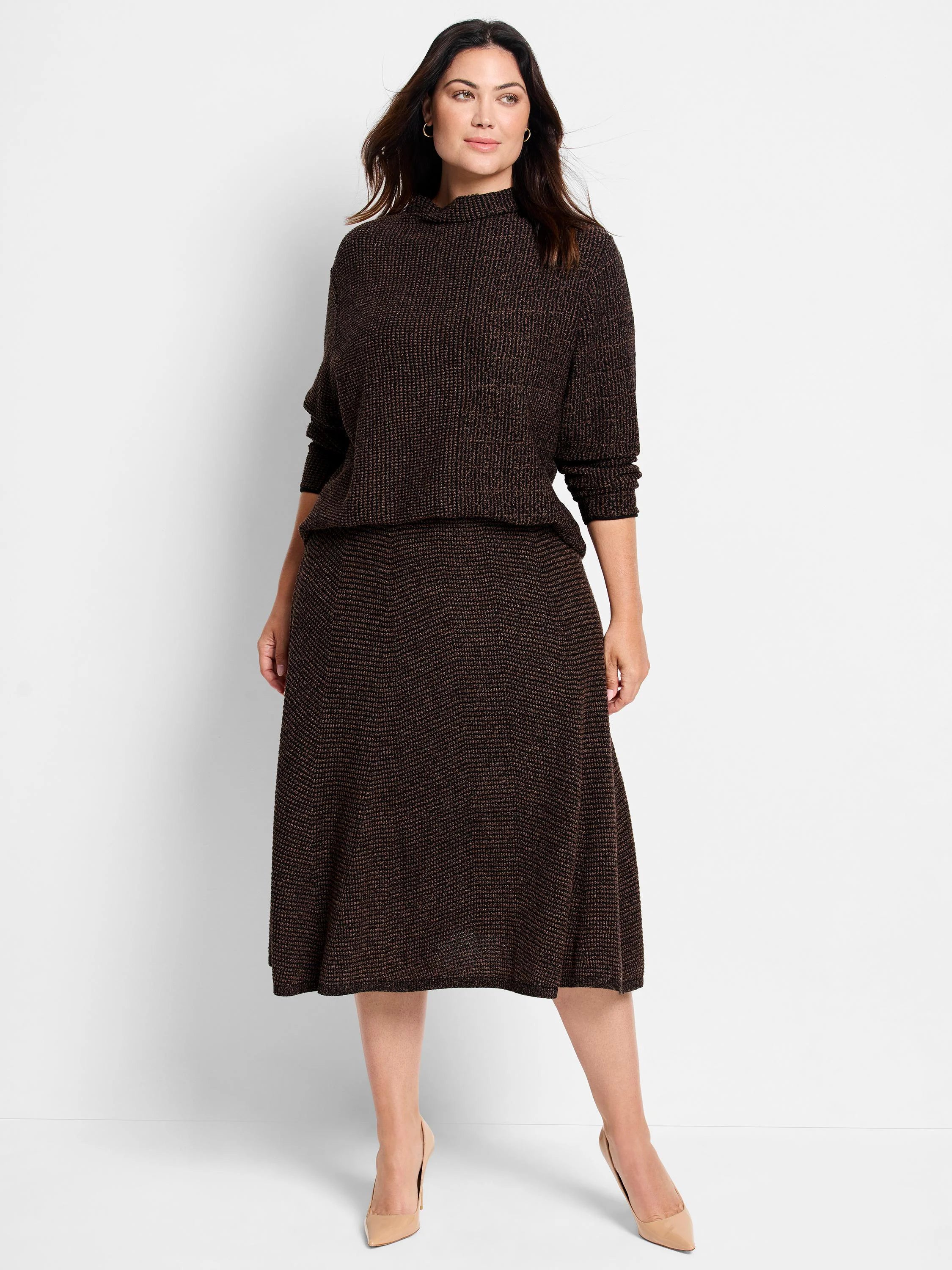 Dark brown pixel knit sweater with bronze flecks, high neck, and long sleeves. Worn by a model with a matching skirt.