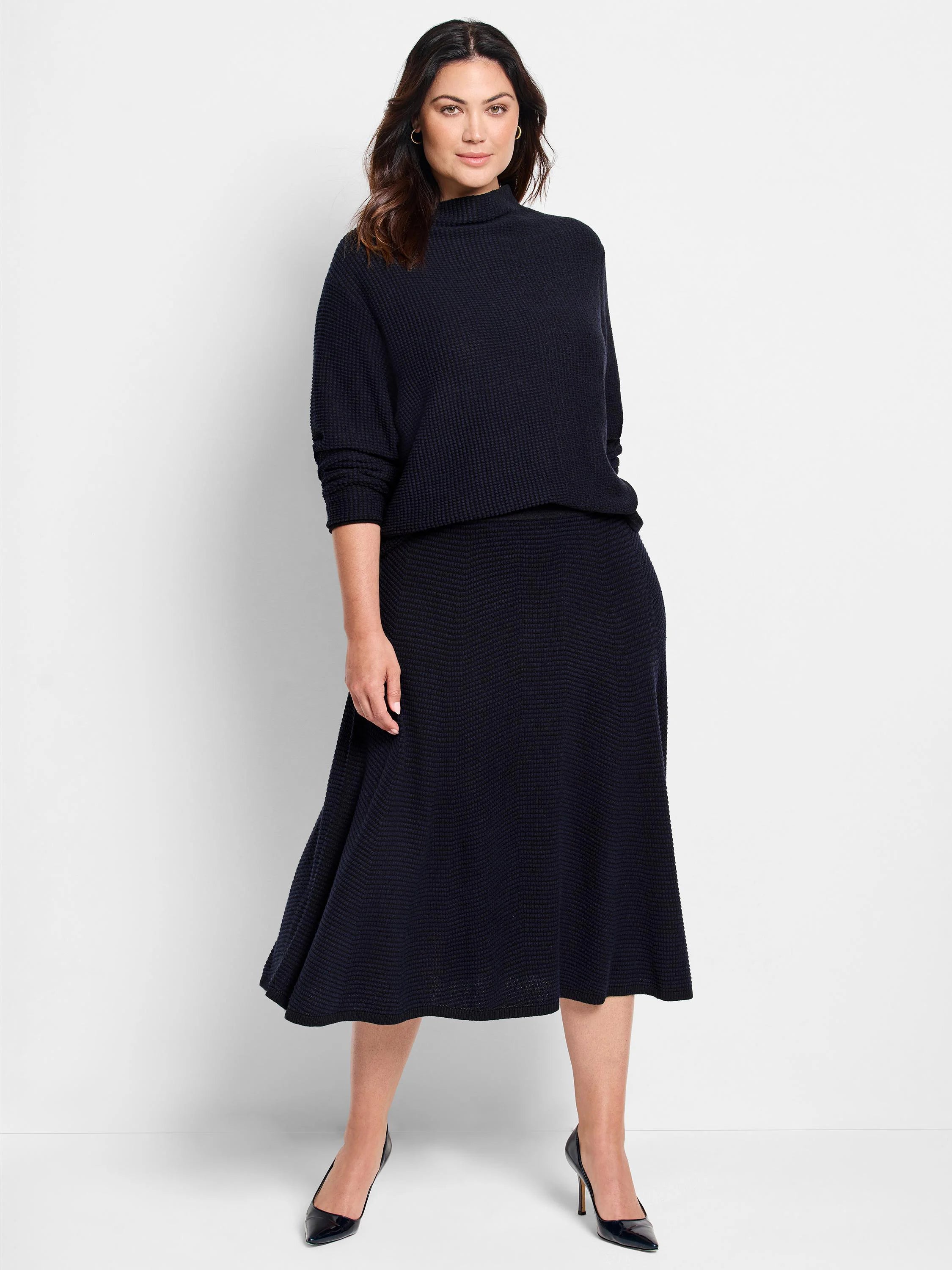 Dark navy blue, textured knit sweater and midi skirt set. High mock neck on sweater. A-line skirt.