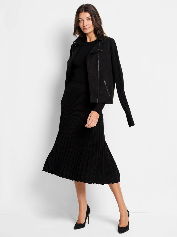 Black ribbed sweater tee. Long sleeves. Shown with black pleated skirt and jacket.