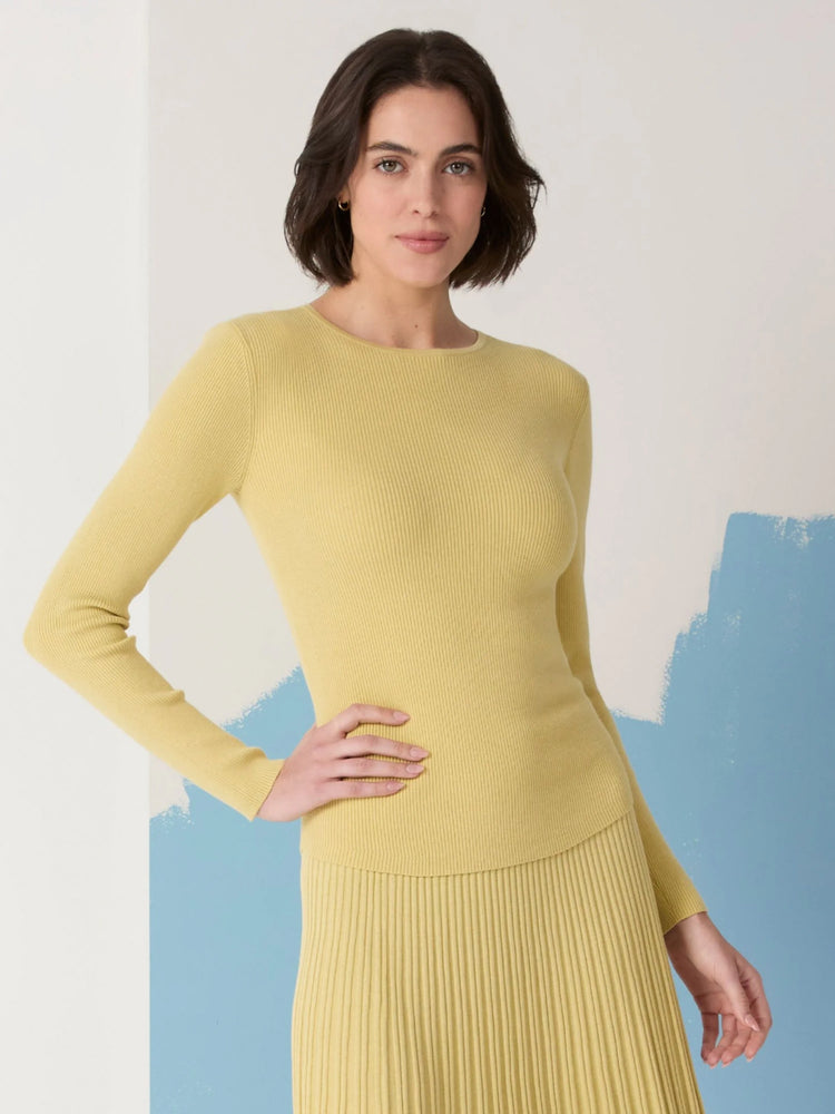 Pale yellow ribbed long-sleeve crewneck sweater. Fine ribbing throughout.