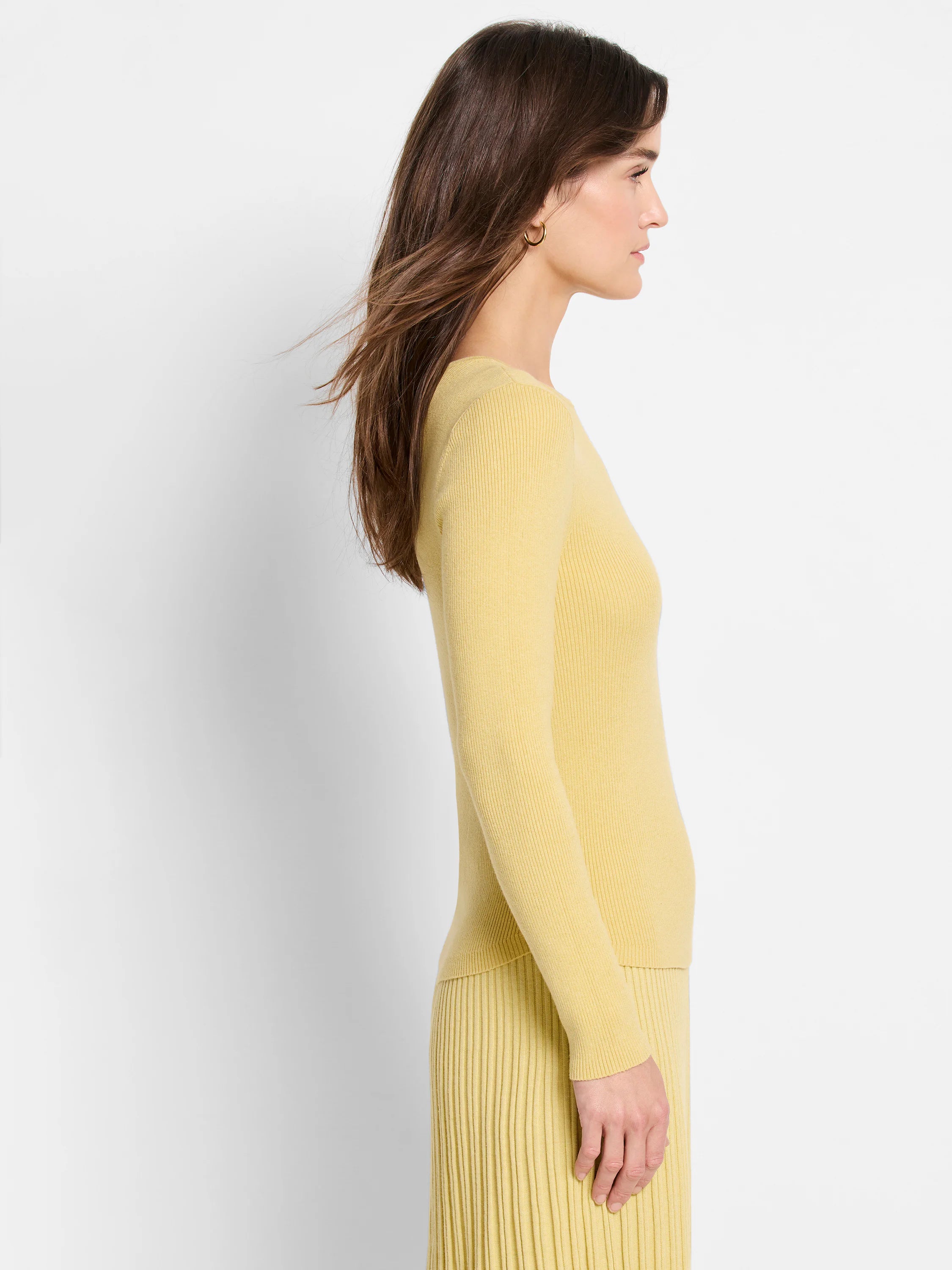 Pale yellow ribbed knit sweater tee; long sleeves, close-fitting.