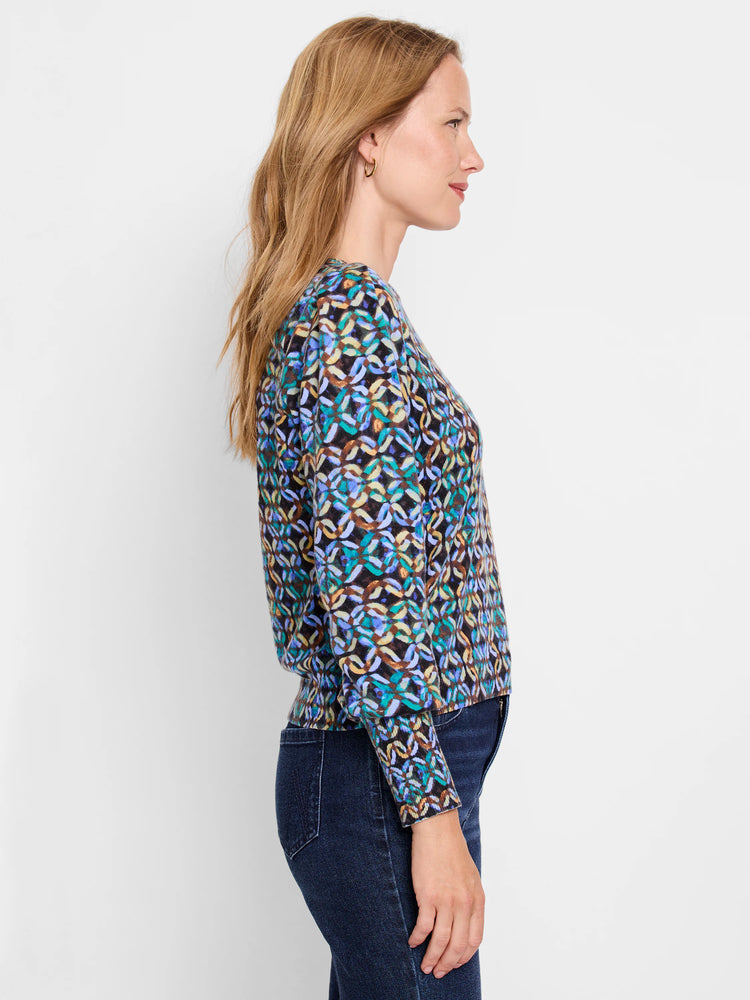 Woman's sweater, blue, teal, brown, and beige abstract pattern on black background. Long sleeves, fitted.