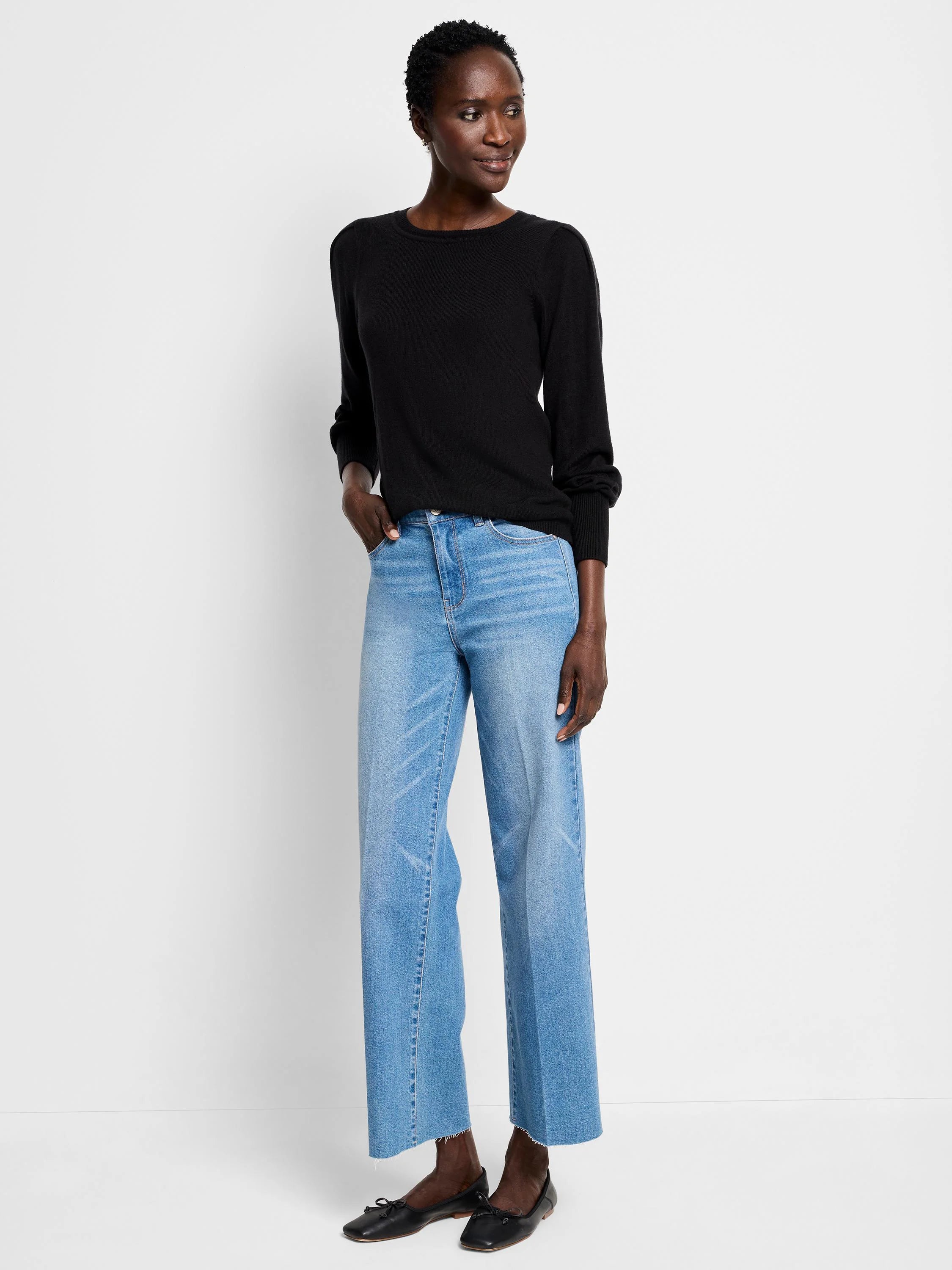 Black crewneck sweater with long, subtly puffed sleeves.