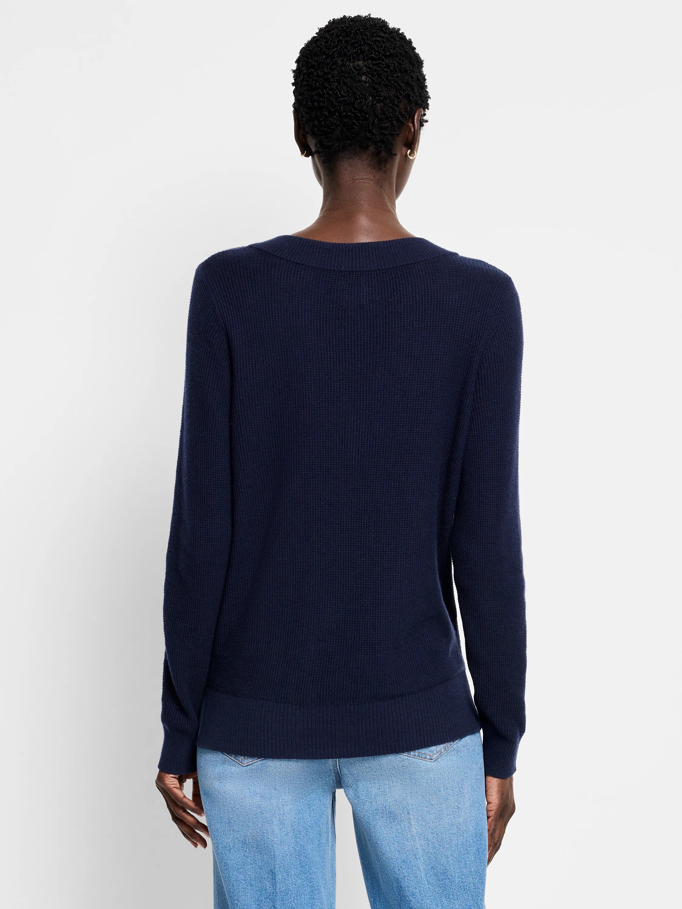 Navy blue waffle stitch sweater, back view. Features ribbed neck, cuffs, and hem.