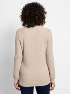 Tan waffle stitch sweater, back view, with long sleeves, ribbed cuffs and hem.