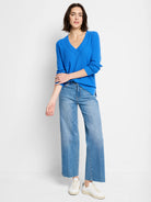 Bright blue waffle stitch V-neck sweater with long sleeves and side slits.