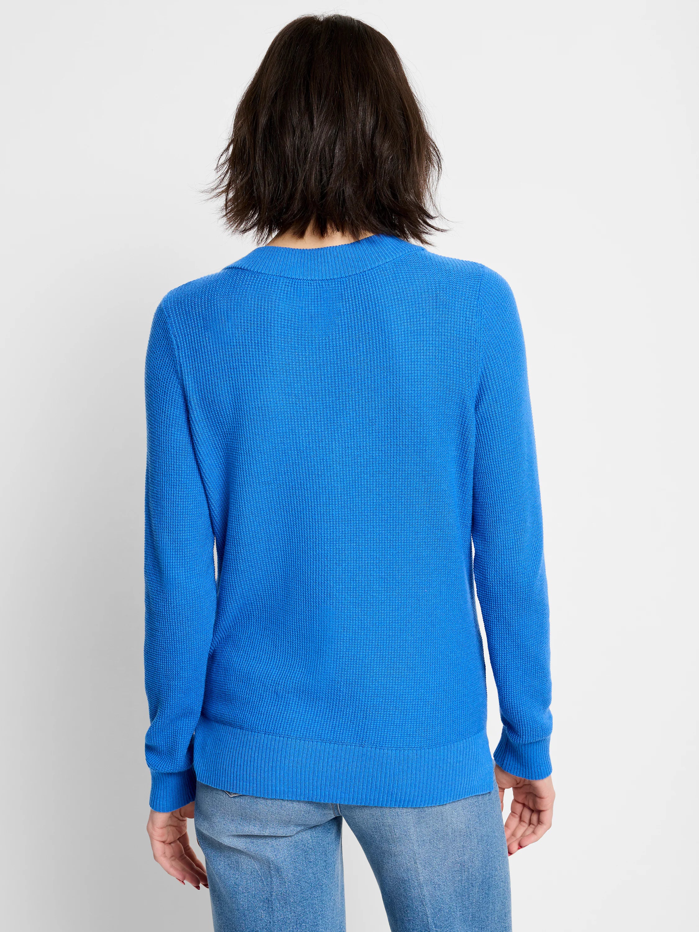 Back view: royal blue waffle stitch sweater with long sleeves, ribbed crew neck, cuffs, and hem.