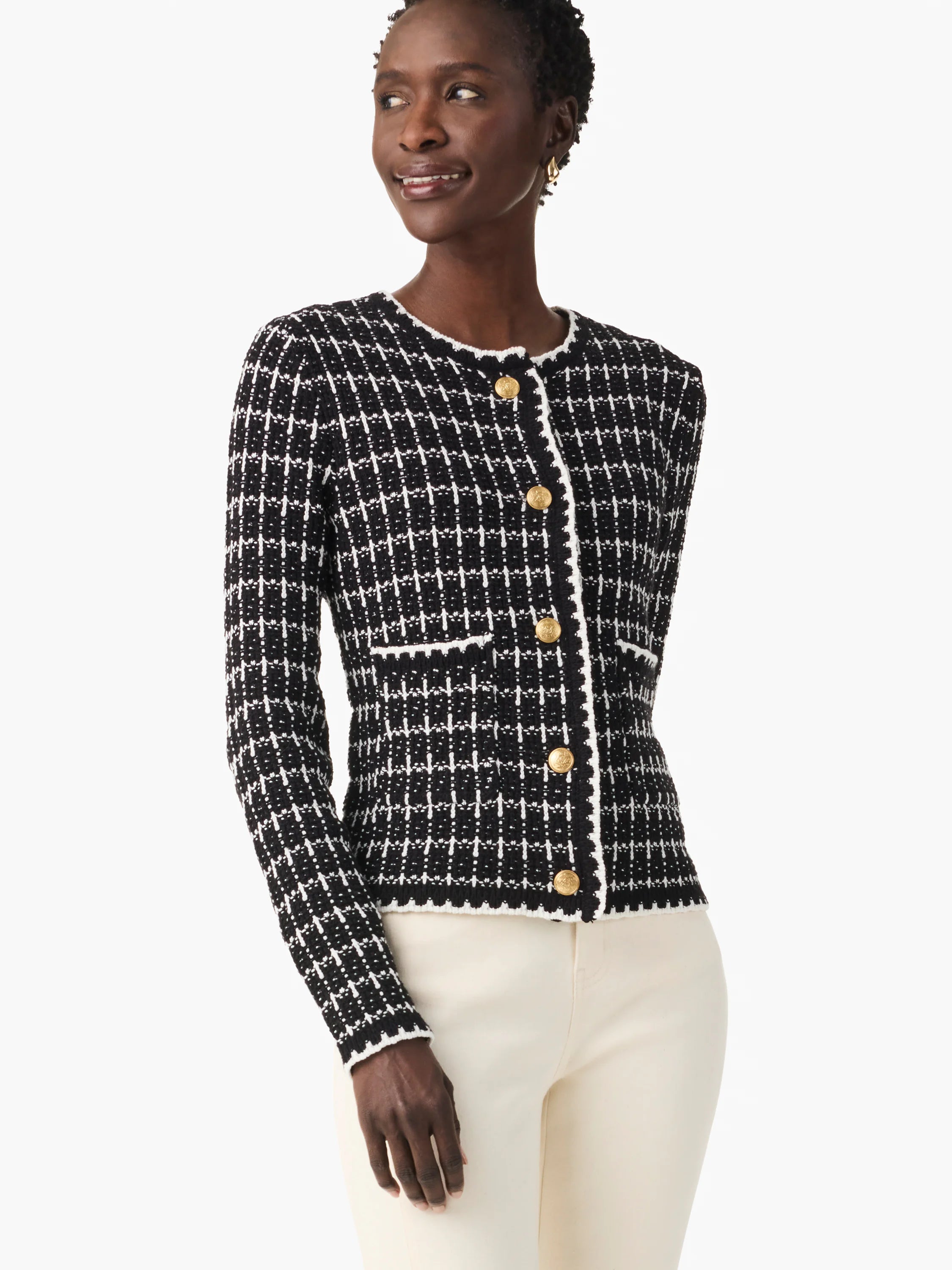 Black and white tweed jacket with gold buttons, close-fitting, has a grid pattern.