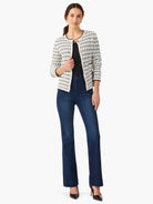 Off-white sweater jacket with black grid pattern, gold buttons, and black trim.