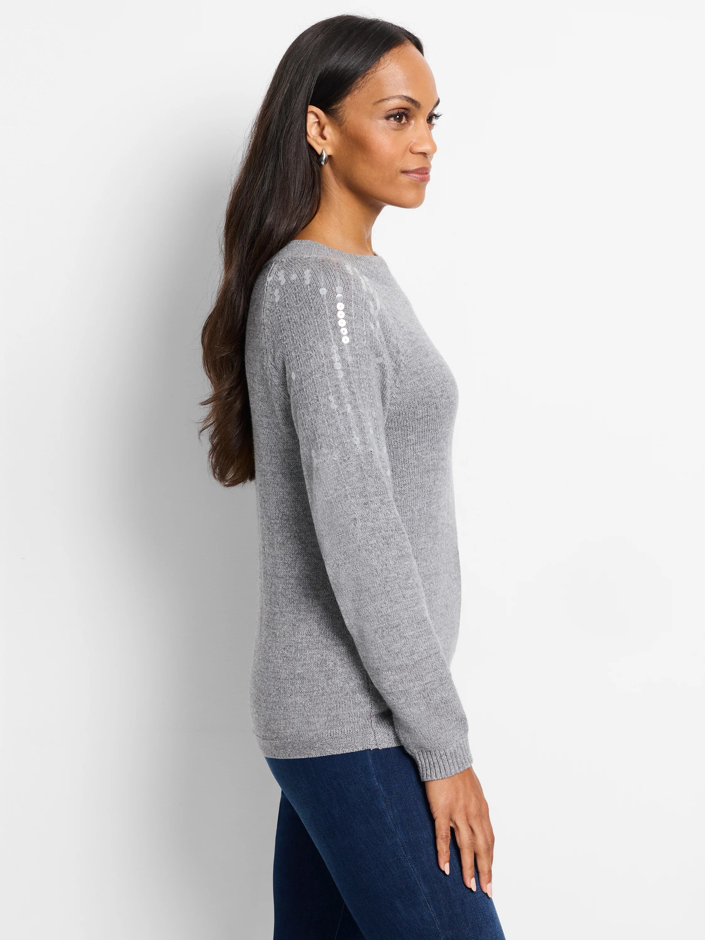 Grey knit sweater with subtle light grey sequins on the shoulders. Long sleeves, round neckline.