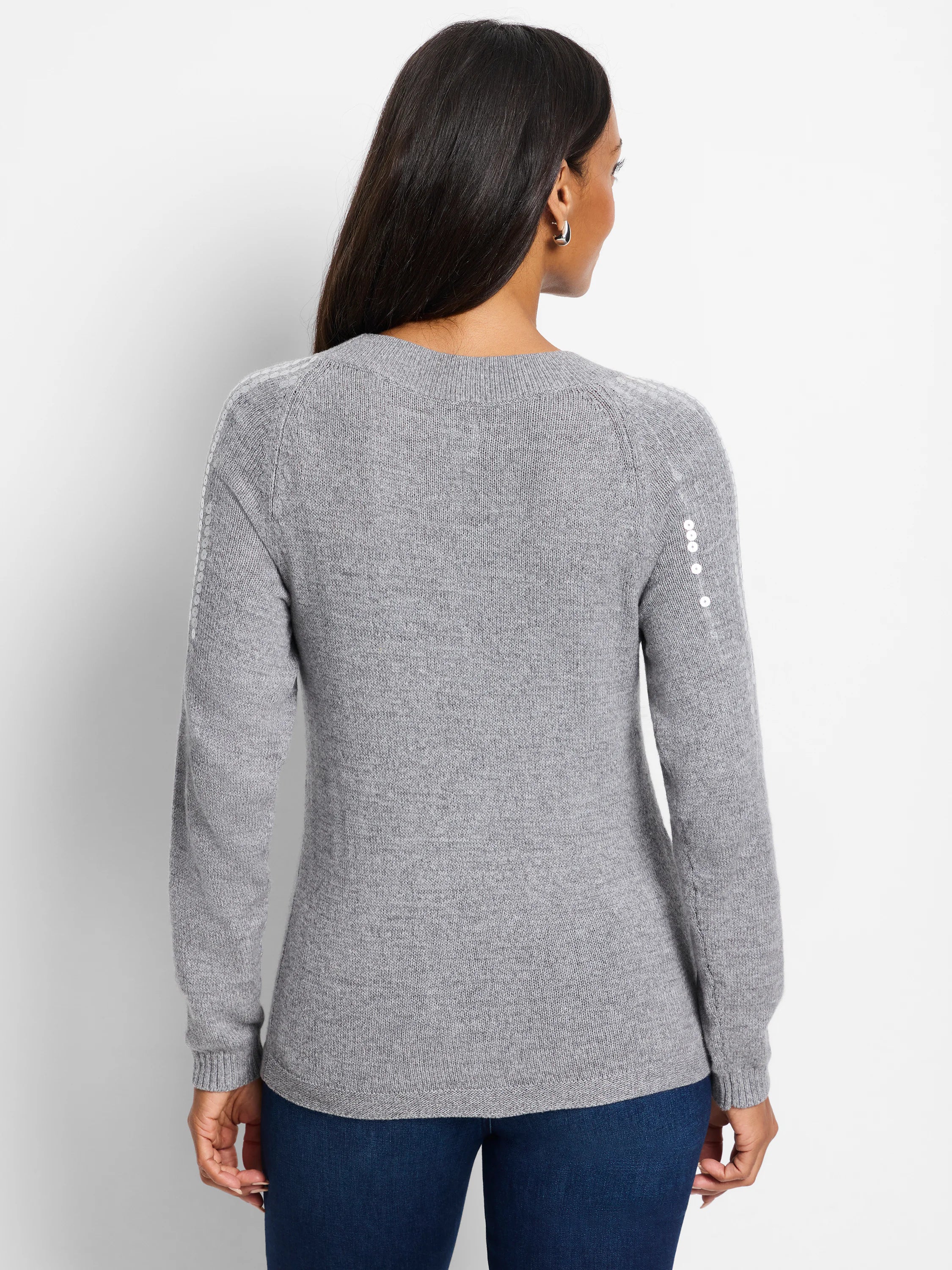 Gray knit sweater, raglan sleeves. Small, light-colored sequins detail shoulder seams.