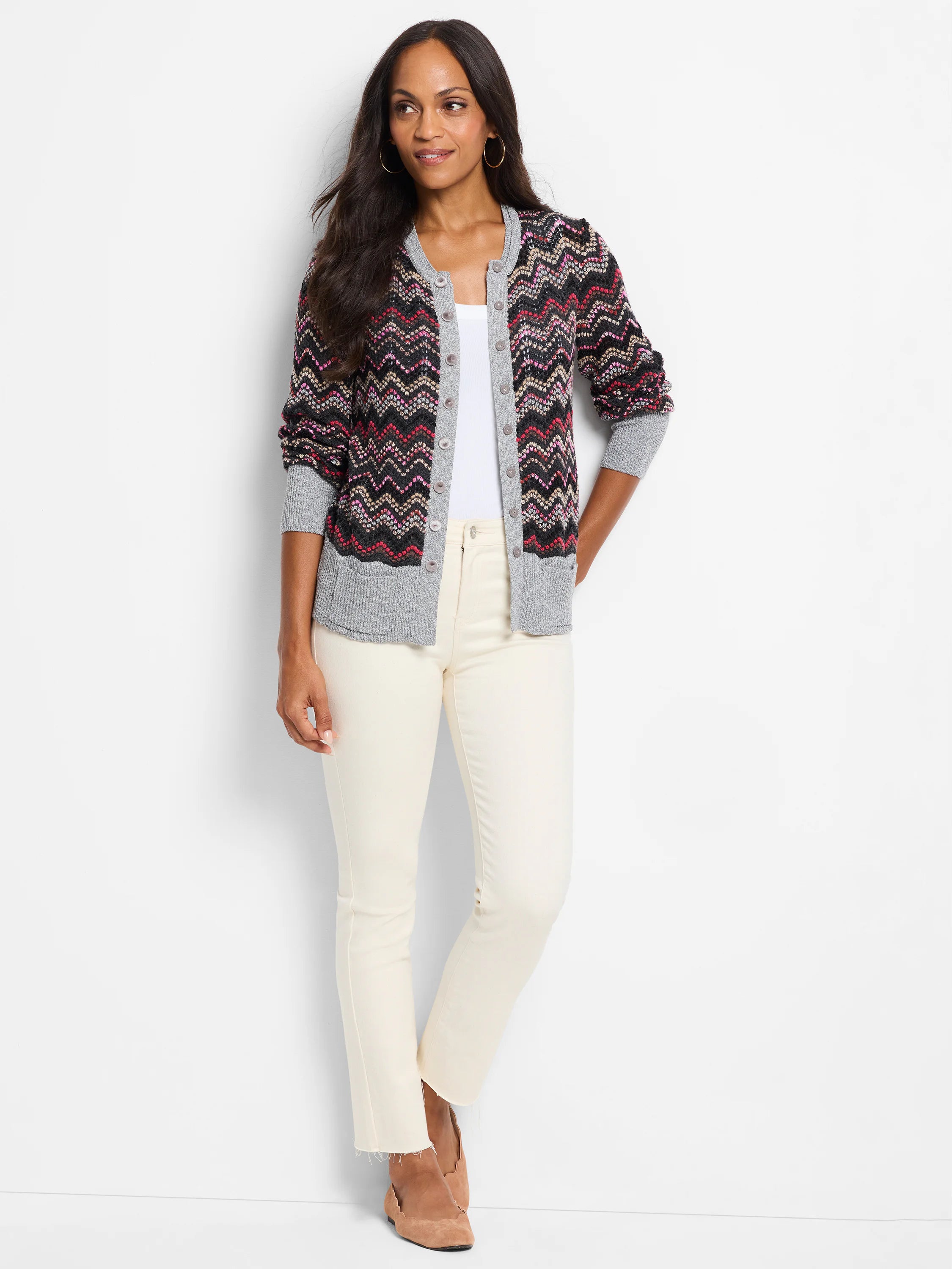 Black cardigan with zigzag pattern in pink, red, & beige. Gray sleeves and hem. Button front.