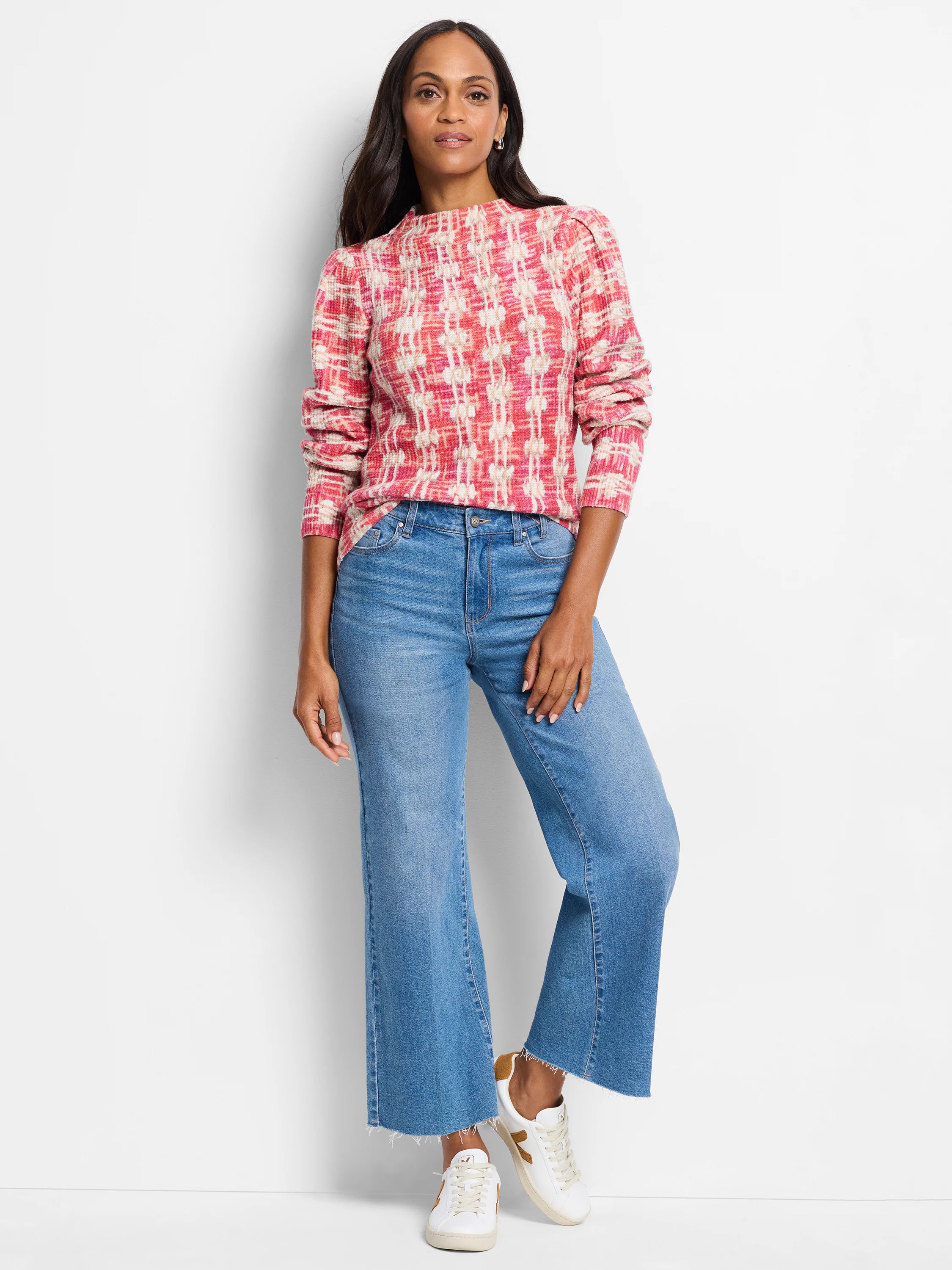 Pink and cream waffle-knit sweater with a mock neck and long sleeves. Abstract pattern.