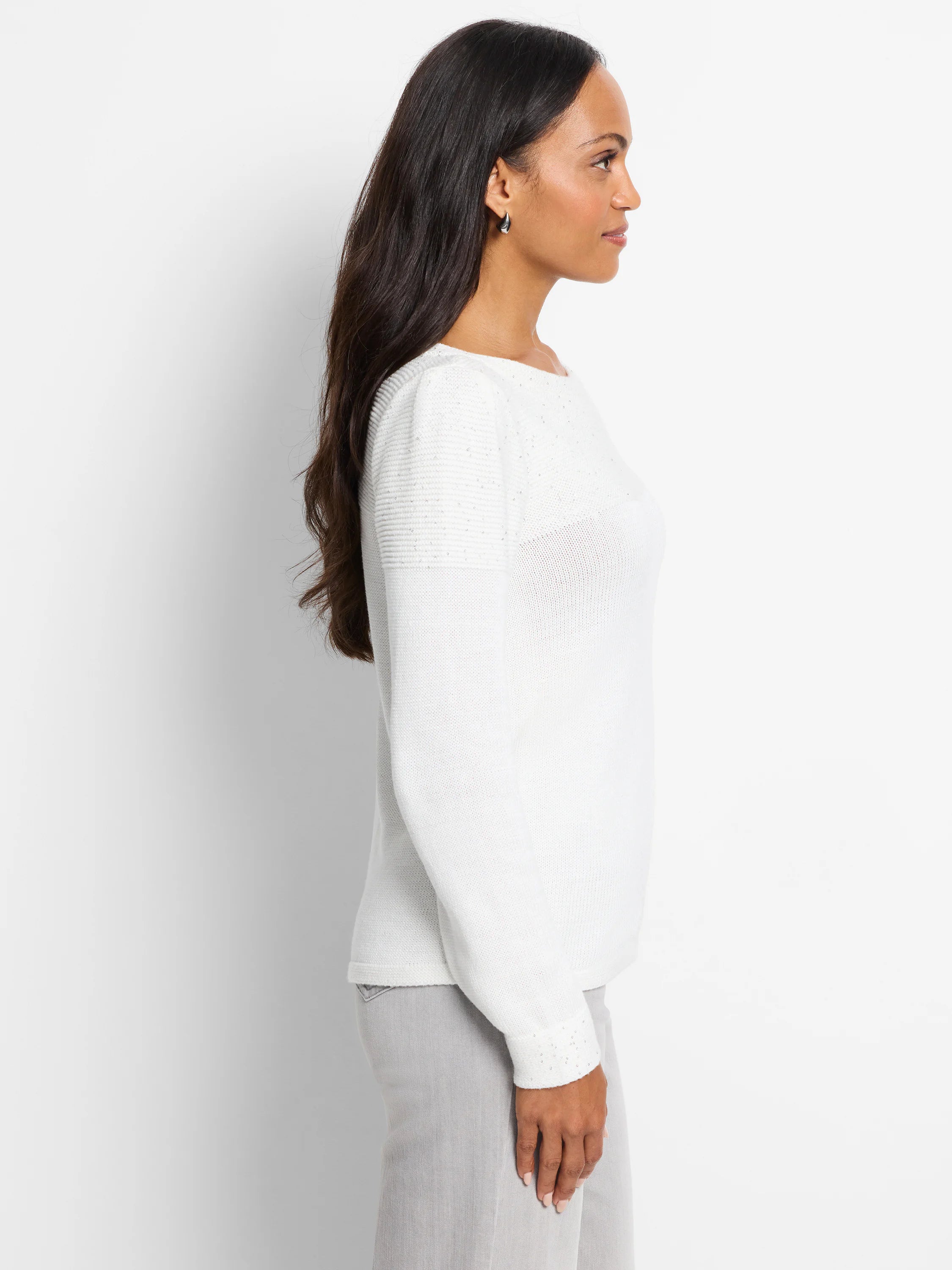 Off-white sweater with subtle sequin detailing on shoulders and cuffs. Long sleeves, boat neck.