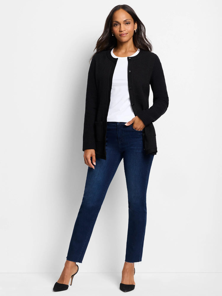 Black buttoned knit jacket. Textured fabric. Model also wears dark wash jeans.