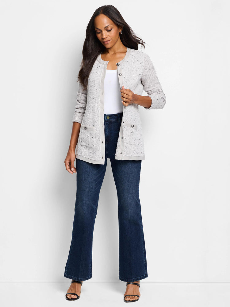 Light gray speckled knit jacket with darker gray trim, button front, and pockets. Model is wearing dark wash jeans.