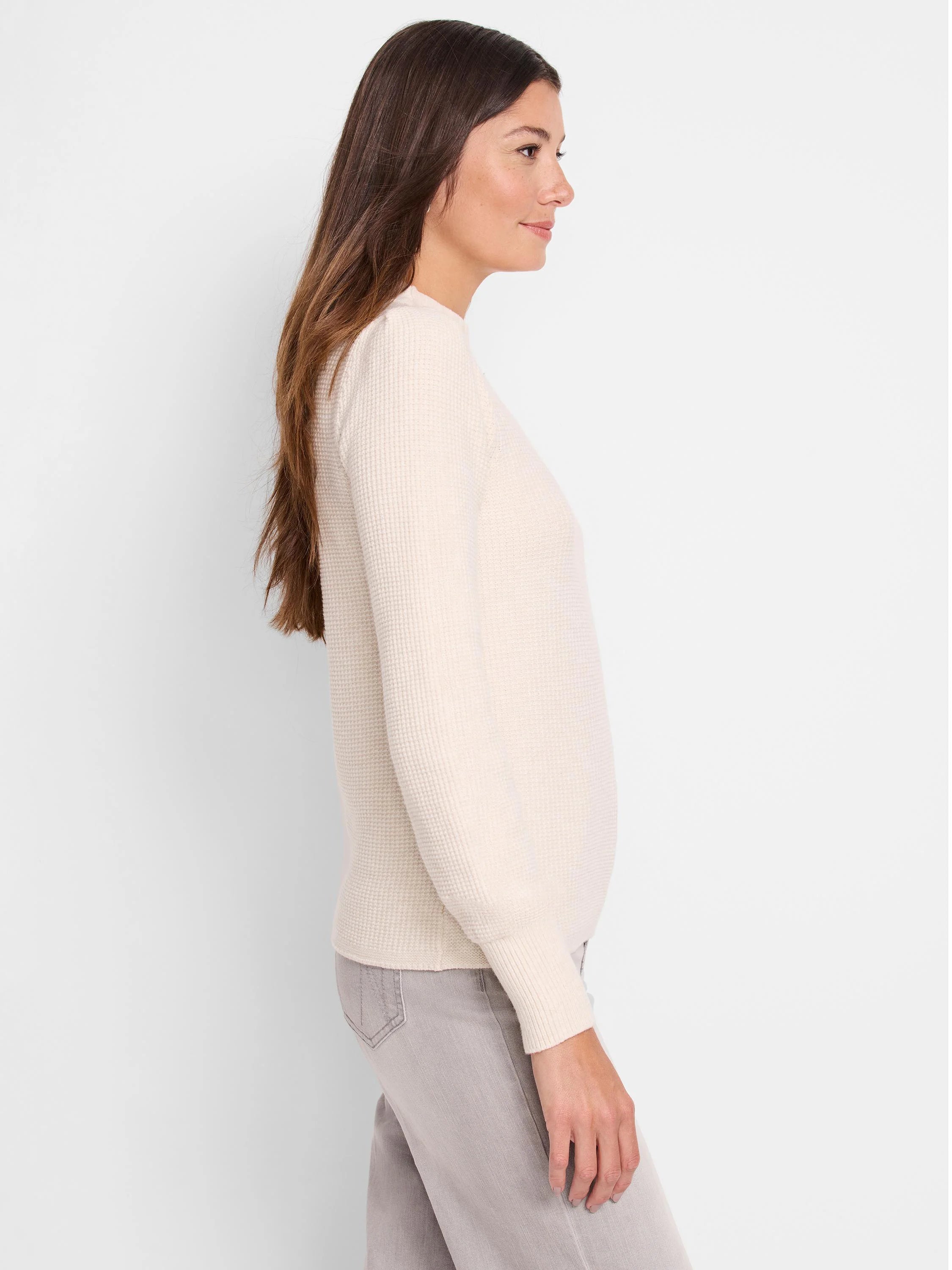 Off-white waffle-knit sweater; long sleeves, crew neck.