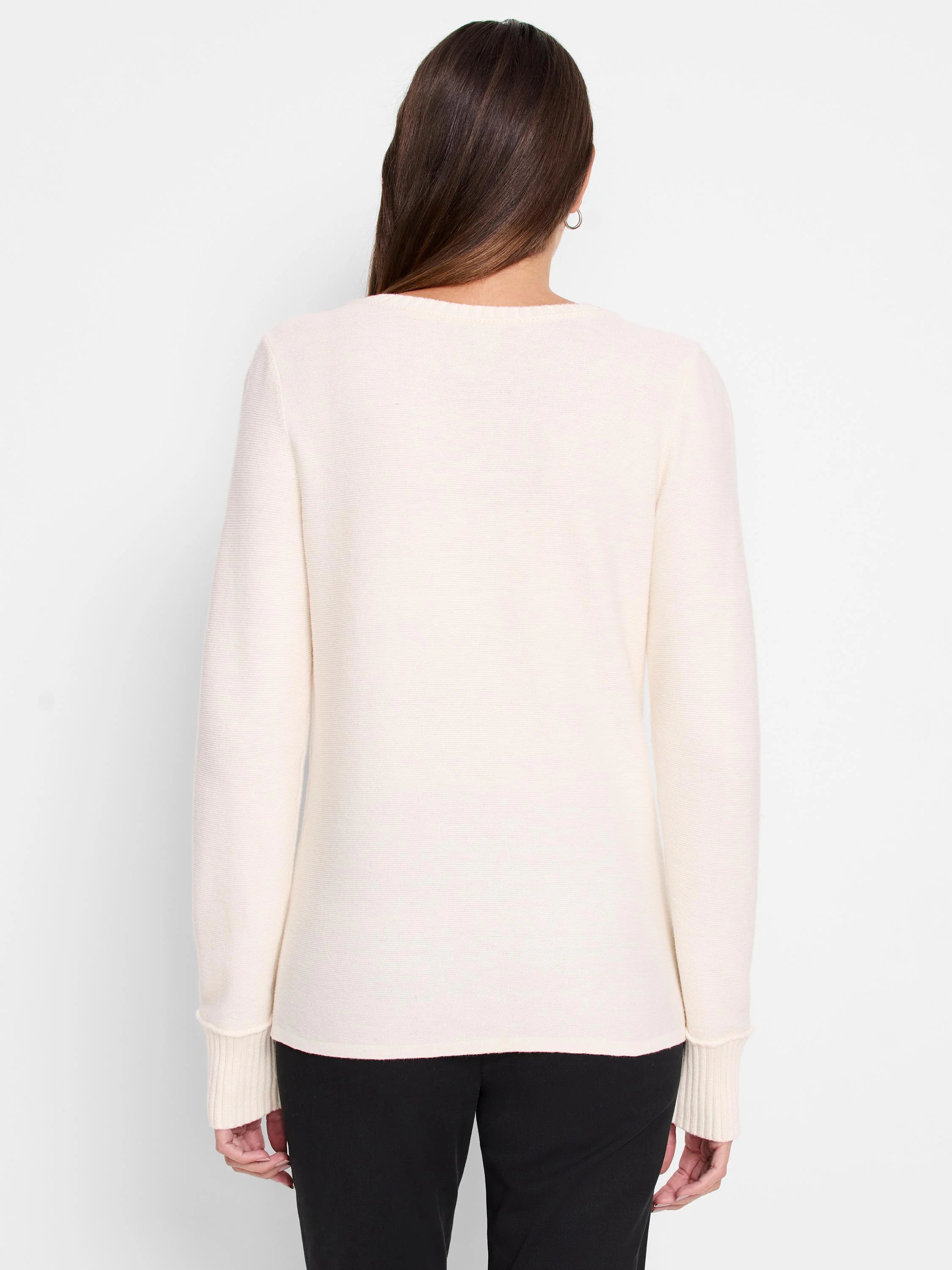 Back of an off-white garter knit sweater with long sleeves and ribbed cuffs.