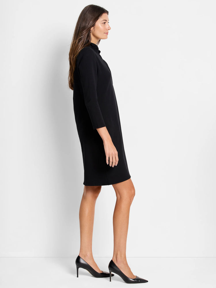 Black mini dress, three-quarter sleeves, mock turtleneck. A-line silhouette.