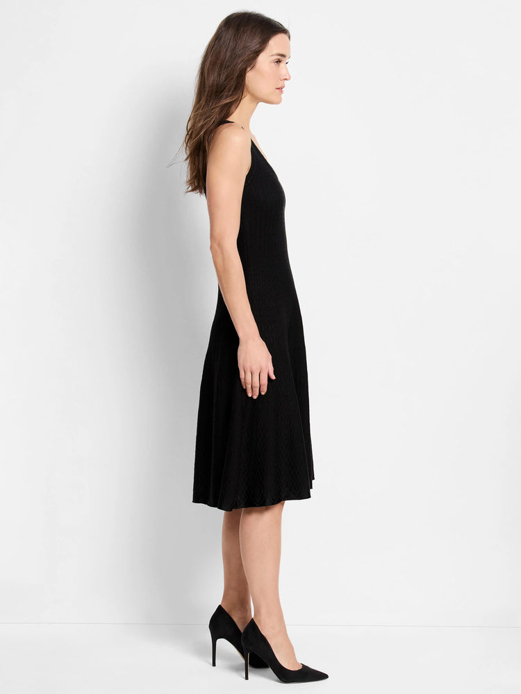 Black, knit, sleeveless dress with a flared skirt and V-neck. Mid-length.