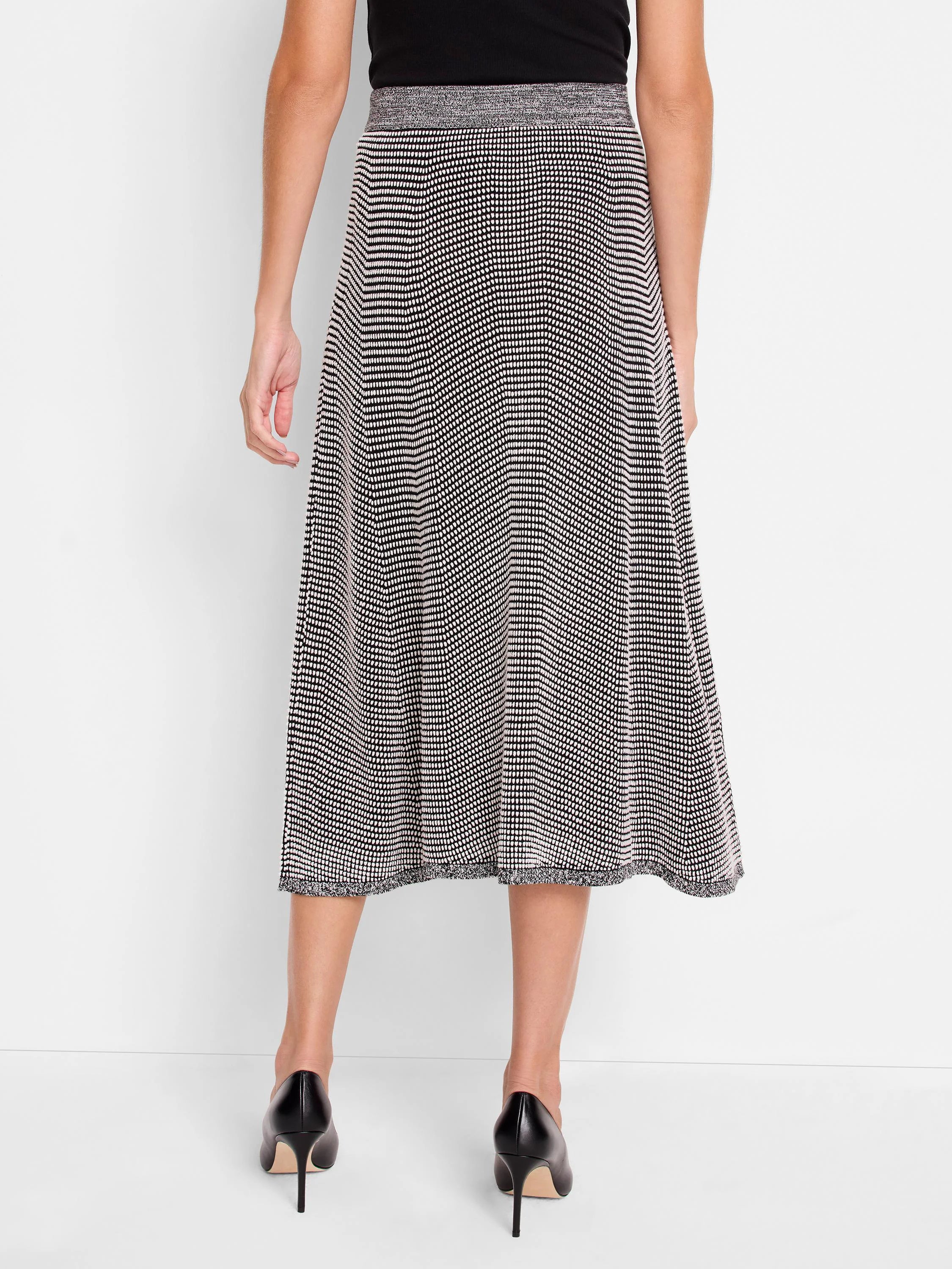 Black & white pixel knit midi skirt, A-line. Light grey marled waistband & raw hem, shown from the back.