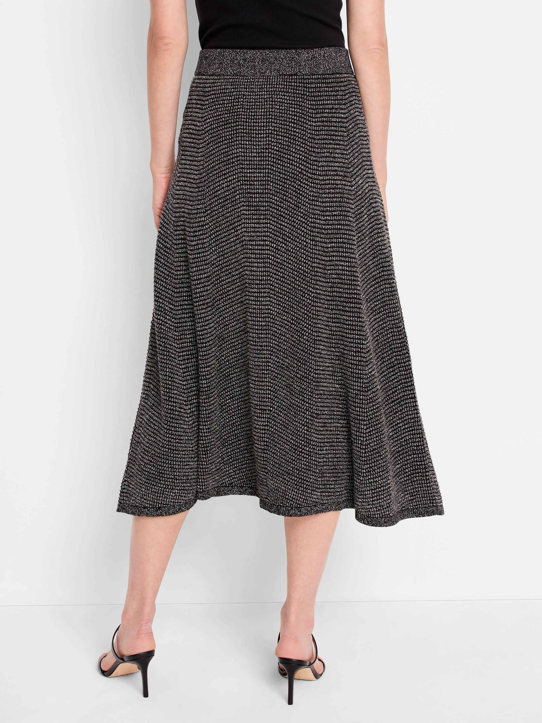 Black A-line midi skirt with a fine, light pixelated knit pattern.