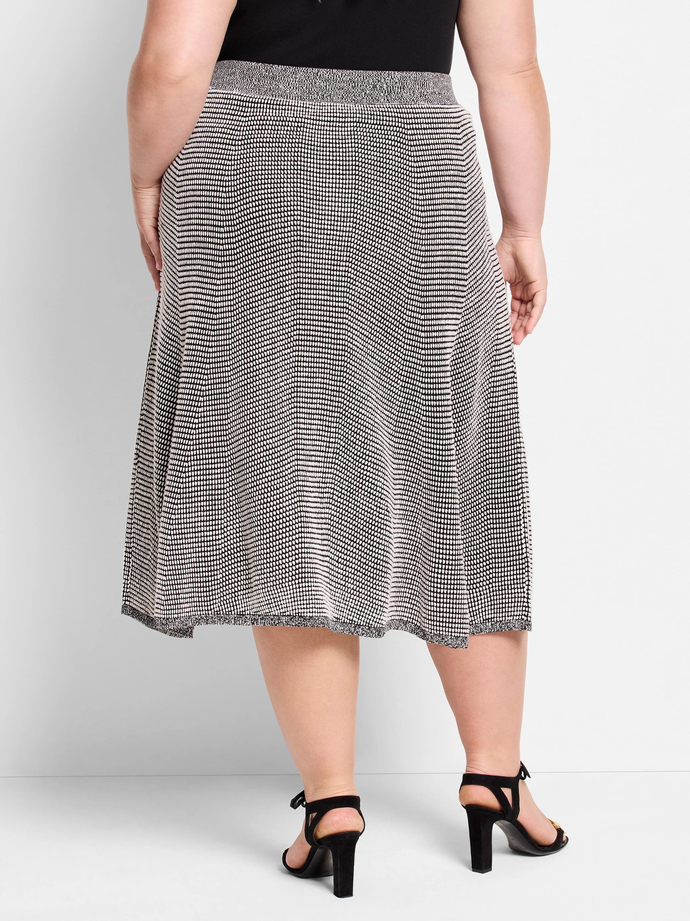 Black and white pixel knit A-line midi skirt, worn on a model from the back.