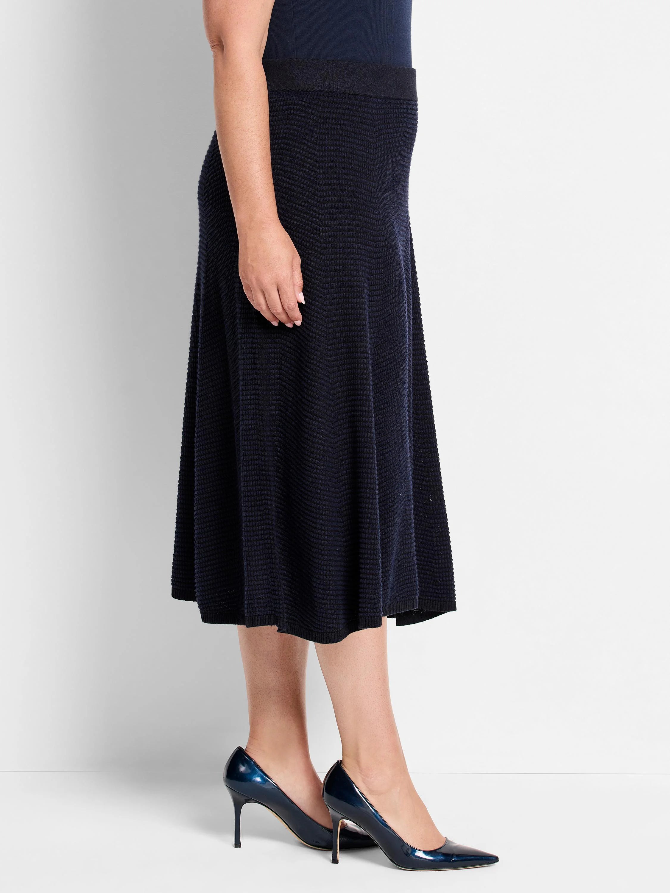 Navy A-line midi skirt with textured pixel knit, featuring a subtle zig-zag pattern.