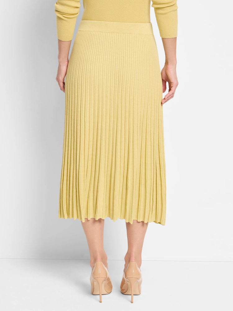 Pale yellow ribbed sweater skirt, midi length, with a wavy hem, shown from the back.