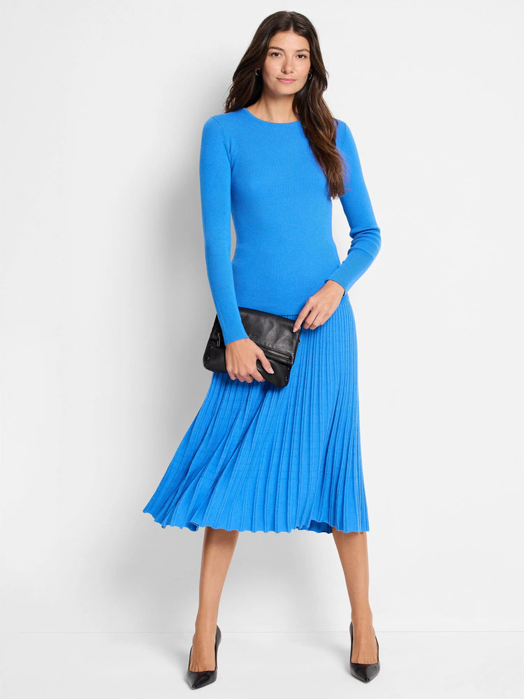 Vibrant blue ribbed sweater skirt, midi length, with a flared, pleated hem. Worn by model with a matching top.