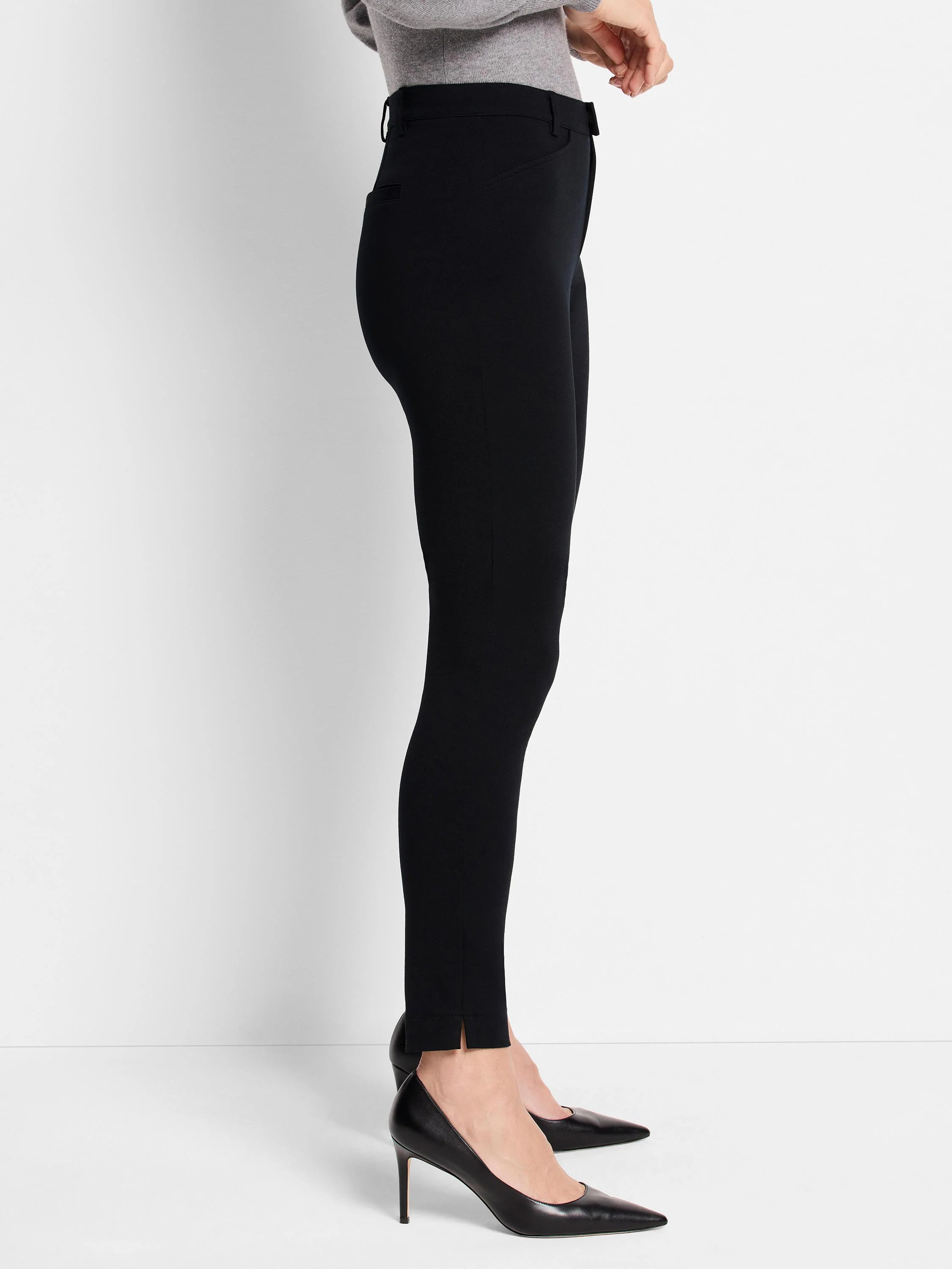 Black knit riding pants; slim fit, ankle-length with side slits.