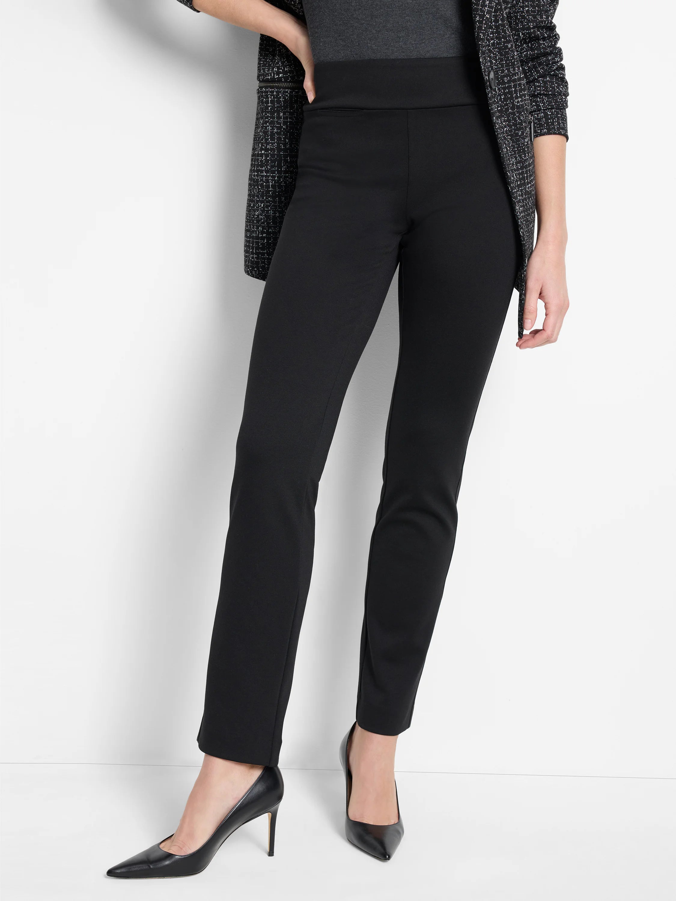 Black, slim, straight leg knit pants with a wide, high waistband and subtle hip pockets.