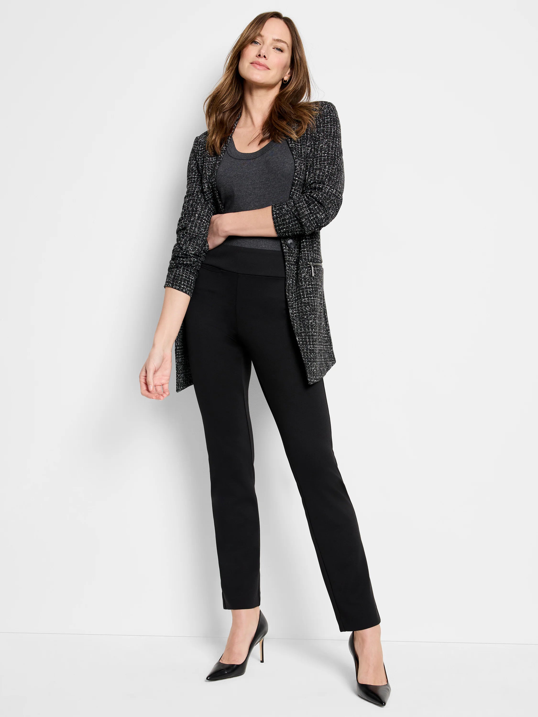 Black knit ankle pants with a smooth, flat front, tapered leg, and ankle length.